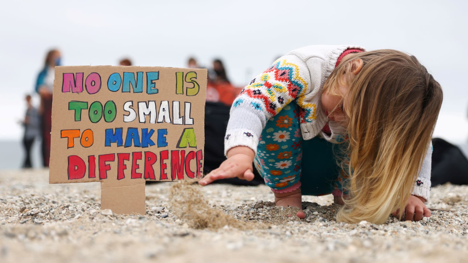 A girl plays with sand during a protest of the Cornwall Climate Youth Alliance in partnership with Fridays for Future and Climate Live, at Gyllyngvase Beach, in Falmouth, on the sidelines of the G7 summit in Cornwall, Britain, June 11, 2021.