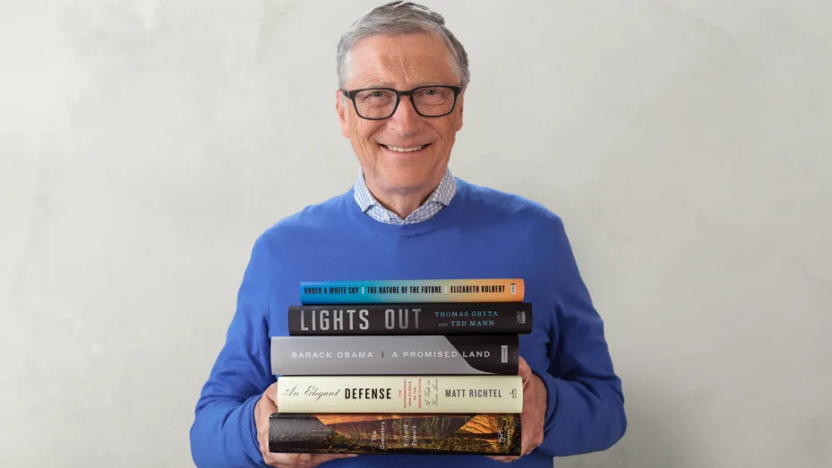 Bill Gates with the books he recommends for summer reading, 2021.