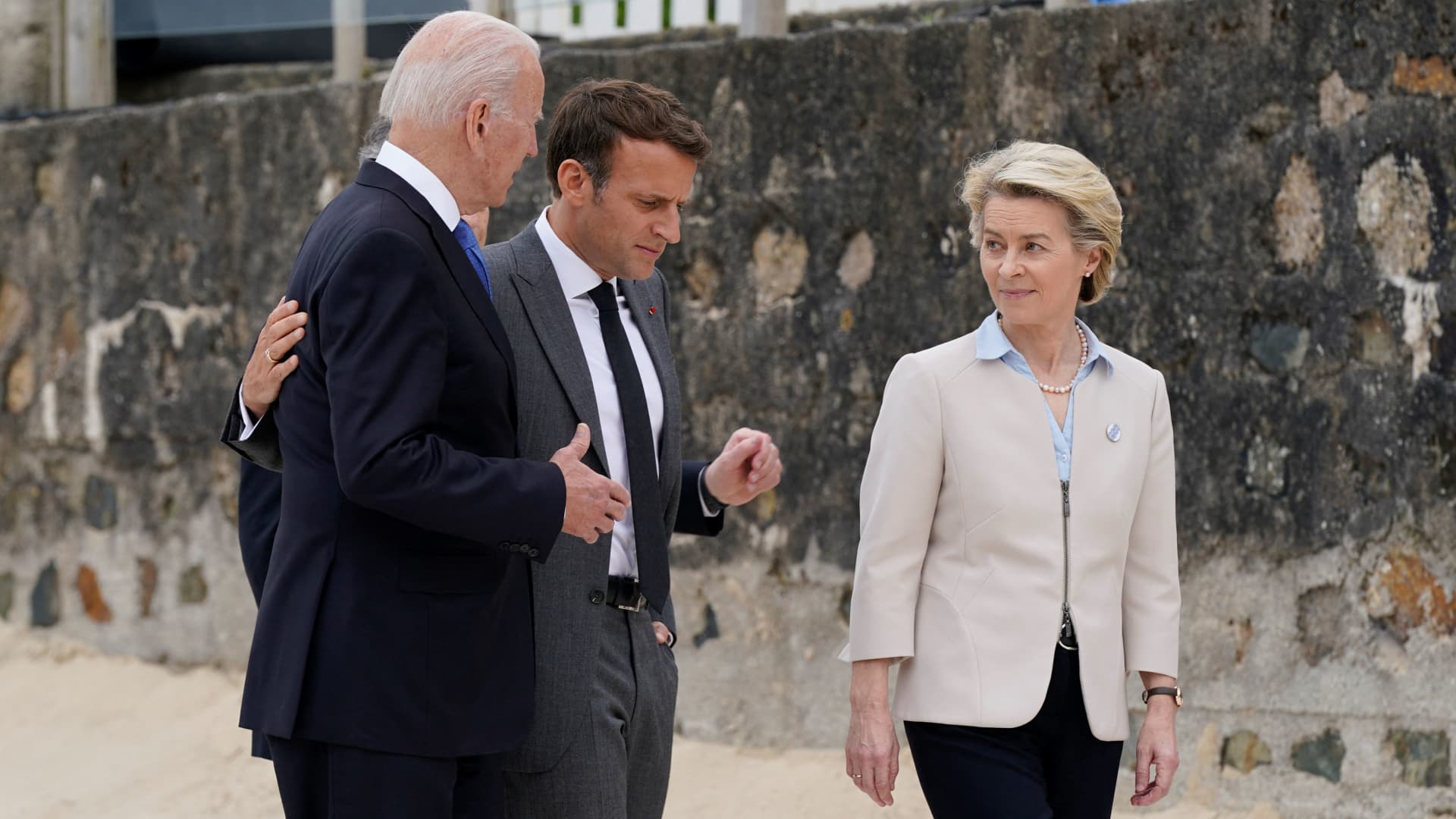 US President Joe Biden (L) and France's President Emmanuel Macron (C) talk with President of the European Commission Ursula von der Leyen after the family photo at the start of the G7 summit in Carbis Bay, Cornwall on June 11, 2021.