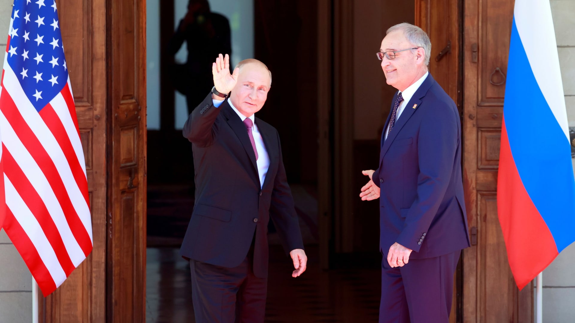 Russia's President Vladimir Putin waves next to Swiss President Guy Parmelin as he arrives at Villa La Grange for the U.S.-Russia summit, in Geneva, Switzerland, June 16, 2021.