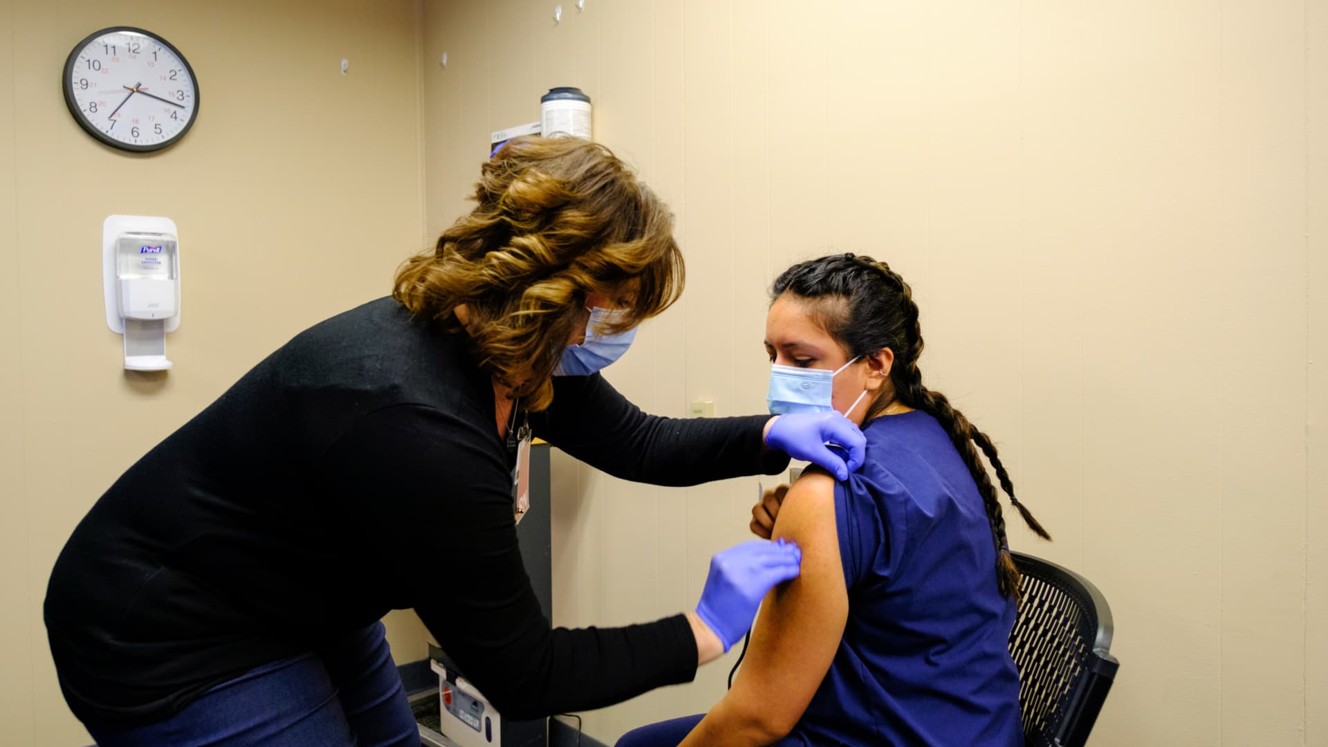 Zaira Hernandez, front line Healthcare worker is vaccinated with the Pfizer covid-19 vaccine by Amy Meek at IU Health Bloomington.