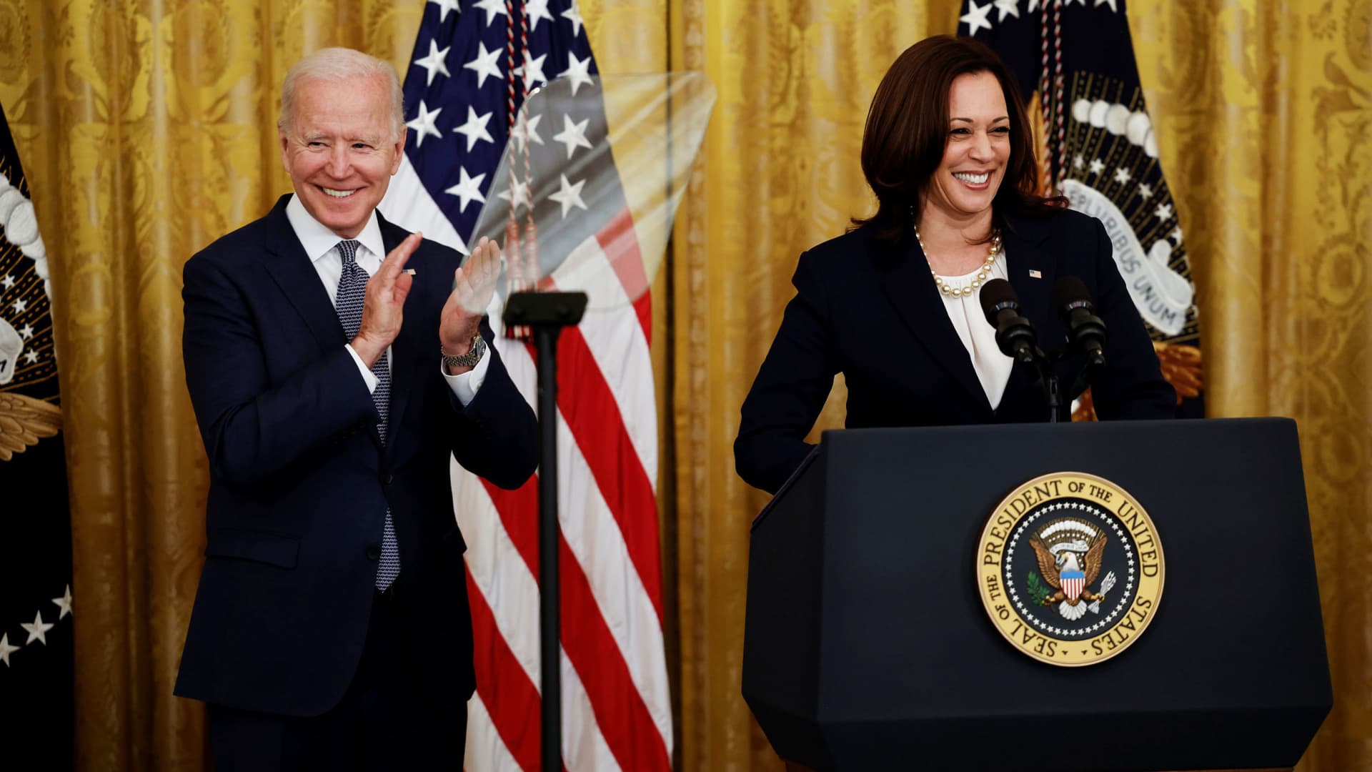 U.S. President Joe Biden applauds Vice President Kamala Harris as they arrive to marking the signing of the Juneteenth National Independence Day Act into law in the East Room of the White House in Washington, June 17, 2021.