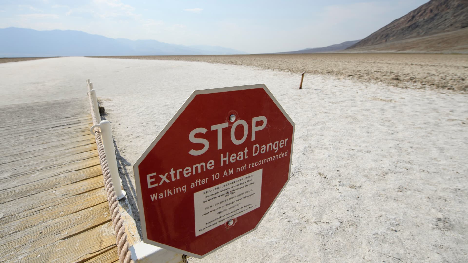 Signage warns of extreme heat danger at the salt flats of Badwater Basin inside Death Valley National Park on June 17, 2021 in Inyo County, California.