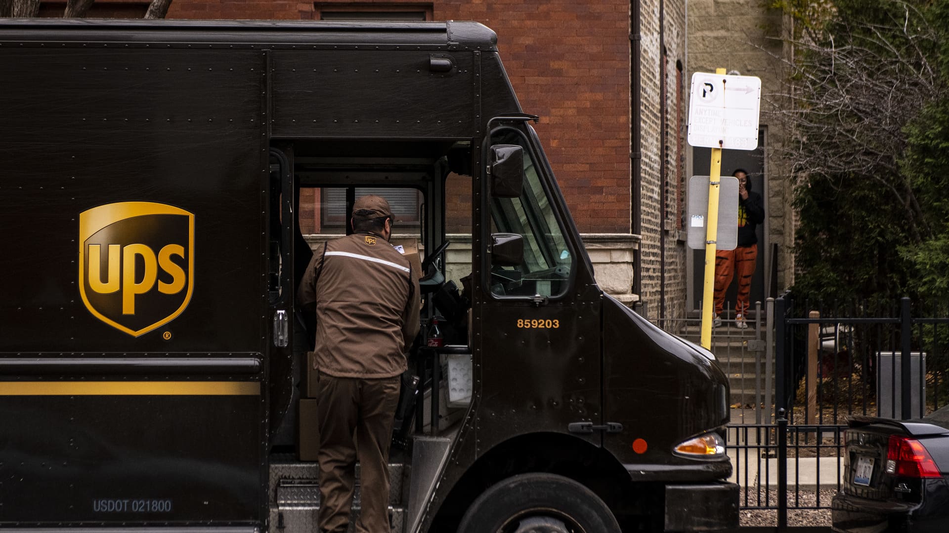 A United Parcel Service driver unloads a package in the Lincoln Park neighborhood of Chicago, Illinois, US, on Monday, Nov.  30, 2020.