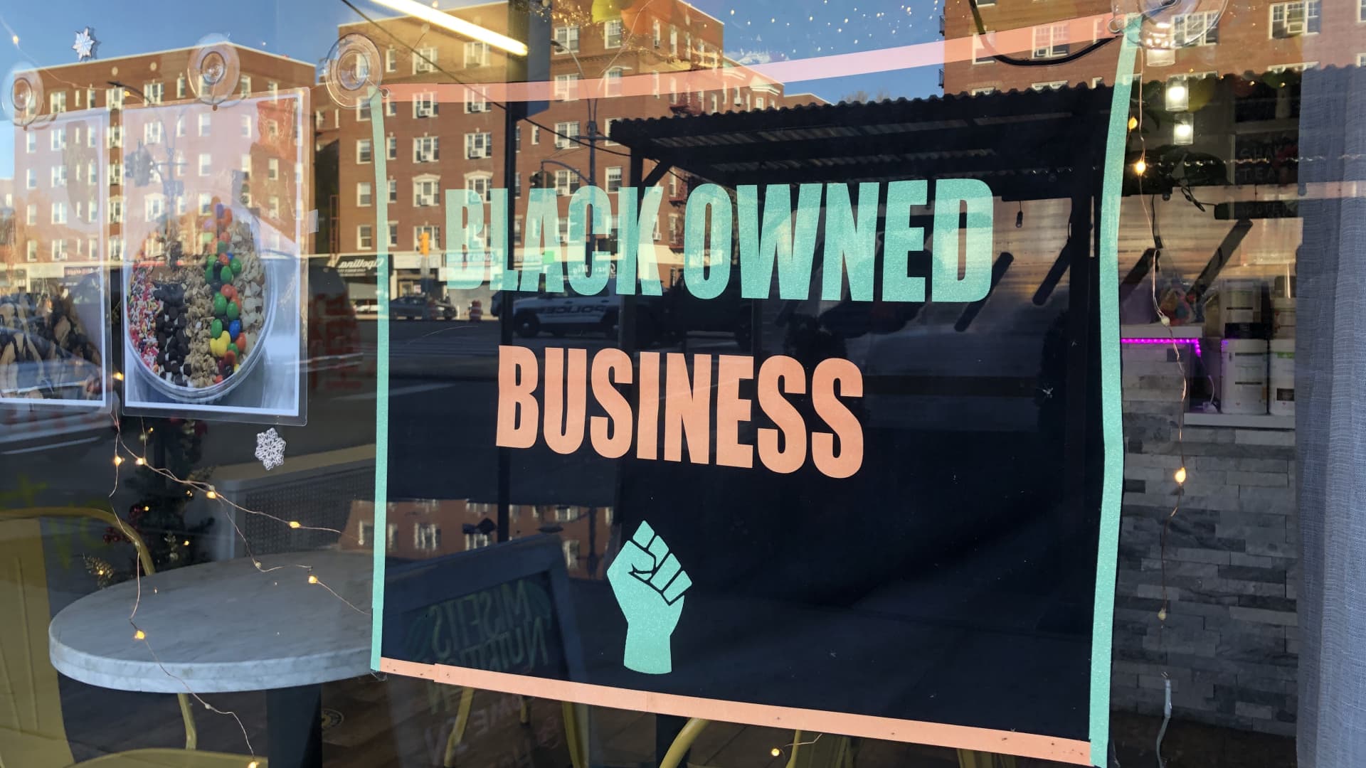 Black Owned Business sign in local storefront window, MisFits Nutrition, Queens, New York.