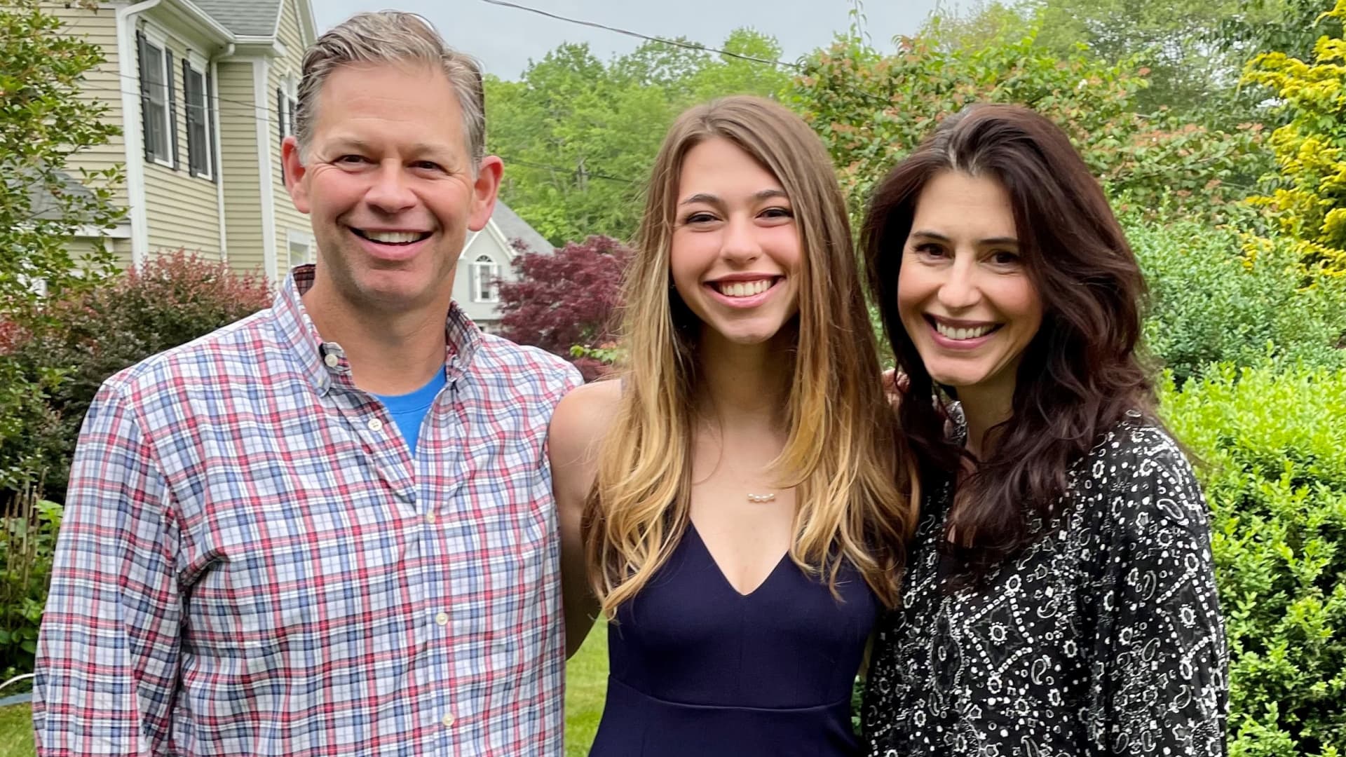 High school graduate Julia Hull (center) of Trumbull, Connecticut, with her parents Tom and Lauren.