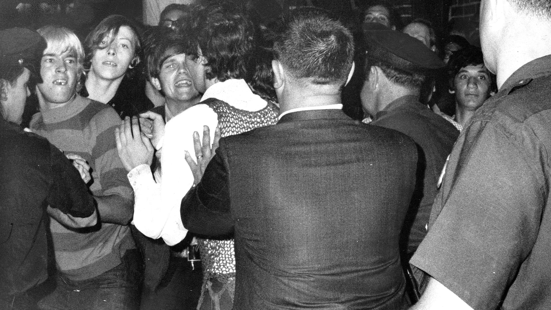 Crowd attempts to impede police outside the Stonewall Inn on Christopher Street in Greenwich Village, New York, June, 1969.