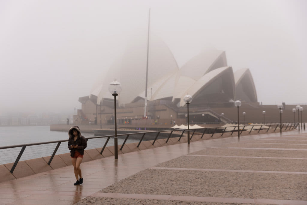 Australia to halve overseas arrivals; hotel quarantines under strain