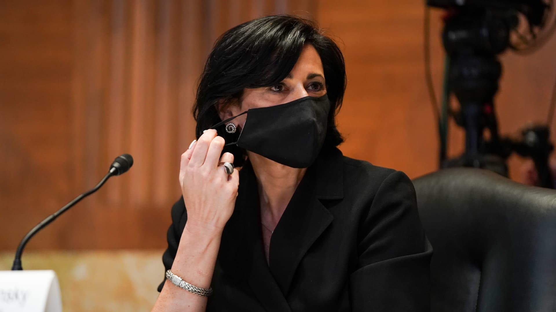 Rochelle Walensky, director of the U.S. Centers for Disease Control and Prevention (CDC), takes off a protective mask during a Senate Appropriations Subcommittee hearing in Washington, D.C., U.S., on Wednesday, May 19, 2021.