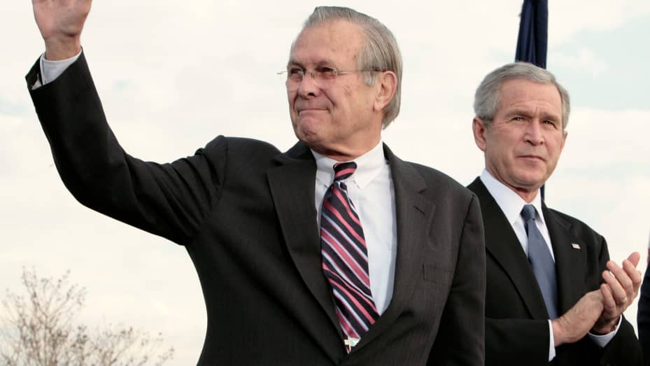 U.S. Secretary of Defense Donald Rumsfeld (L) waves next to U.S. President George W. Bush during the Armed Forces Full Honor Review in Honor of the Secretary of Defense at the Pentagon in Washington December 15, 2006.