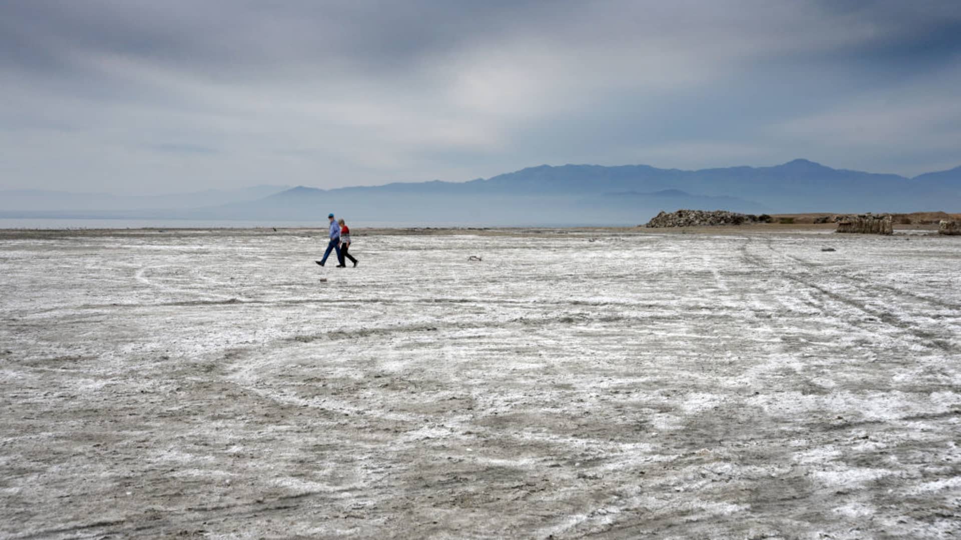 A couple walks toward the shore of the Salton Sea in Southern California. The shallow saline lake was formed accidentlaly in 1905 following the rupture of canal diverting water from the Colorado River to the agricultural area of California's Imperial Valley.