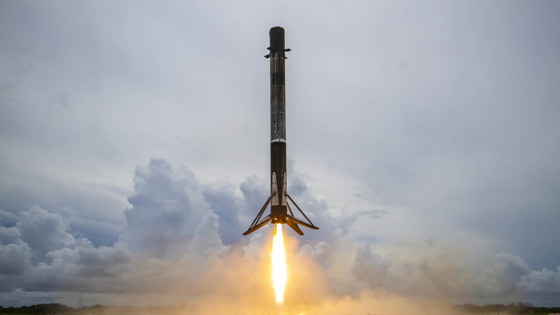 A Falcon 9 rocket booster lands after launching the company's Transporter-2 rideshare mission on June 30, 2021.