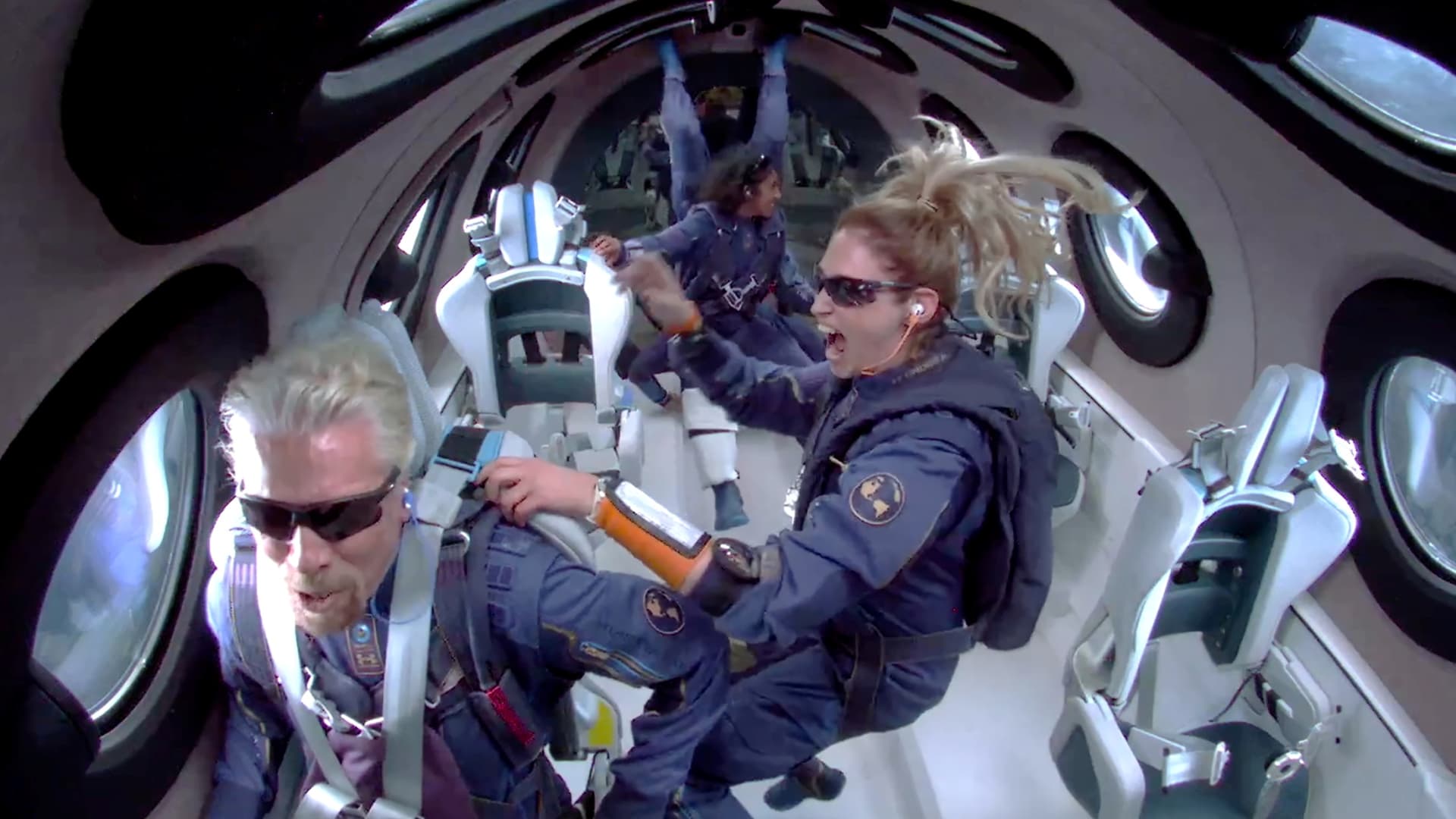 Billionaire Richard Branson makes a statement as crew members Beth Moses and Sirisha Bandla float in zero gravity on board Virgin Galactic's passenger rocket plane VSS Unity after reaching the edge of space above Spaceport America near Truth or Consequences, New Mexico, U.S. July 11, 2021 in a still image from video.