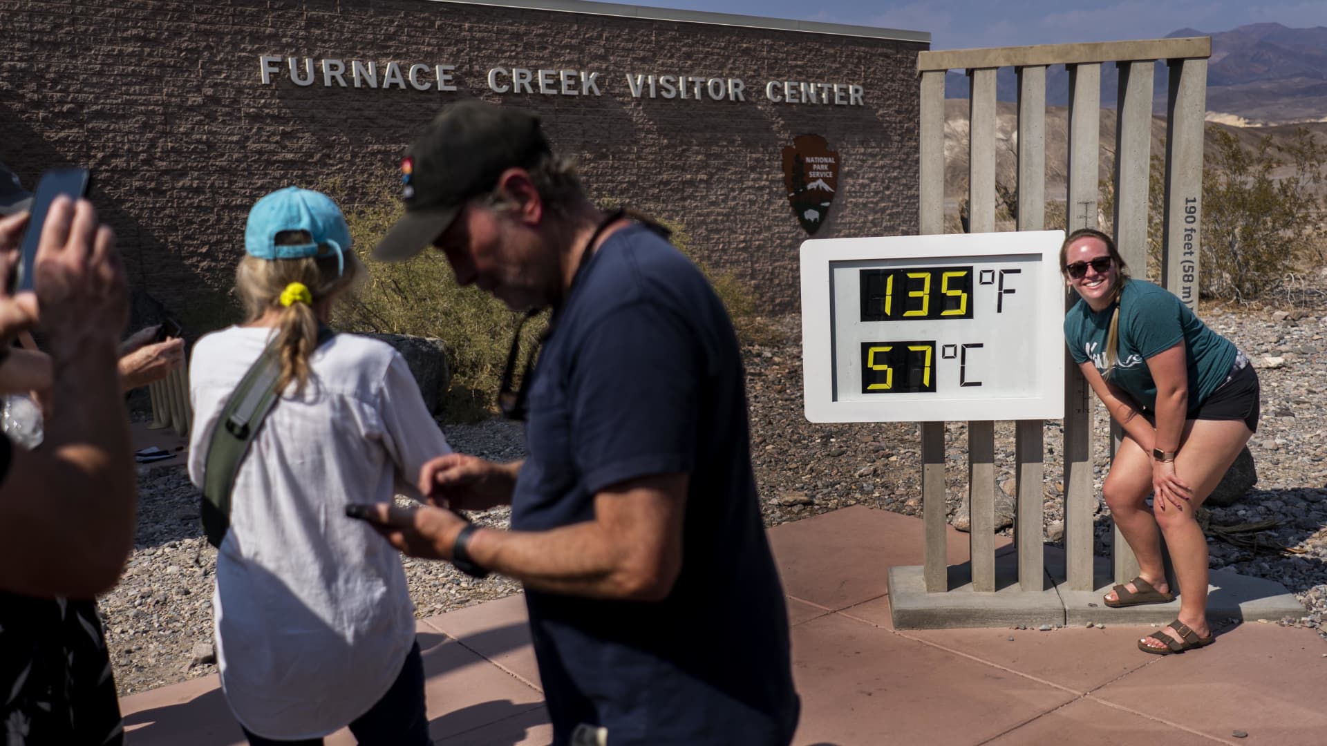 With record setting heat expected tourists stop at the Furnace Creek Visitors Center to take pictures in front of the thermometer showing the current extreme record breaking temperature of 135 degrees Fahrenheit in Death Valley National Park, California Saturday July 10, 2021.