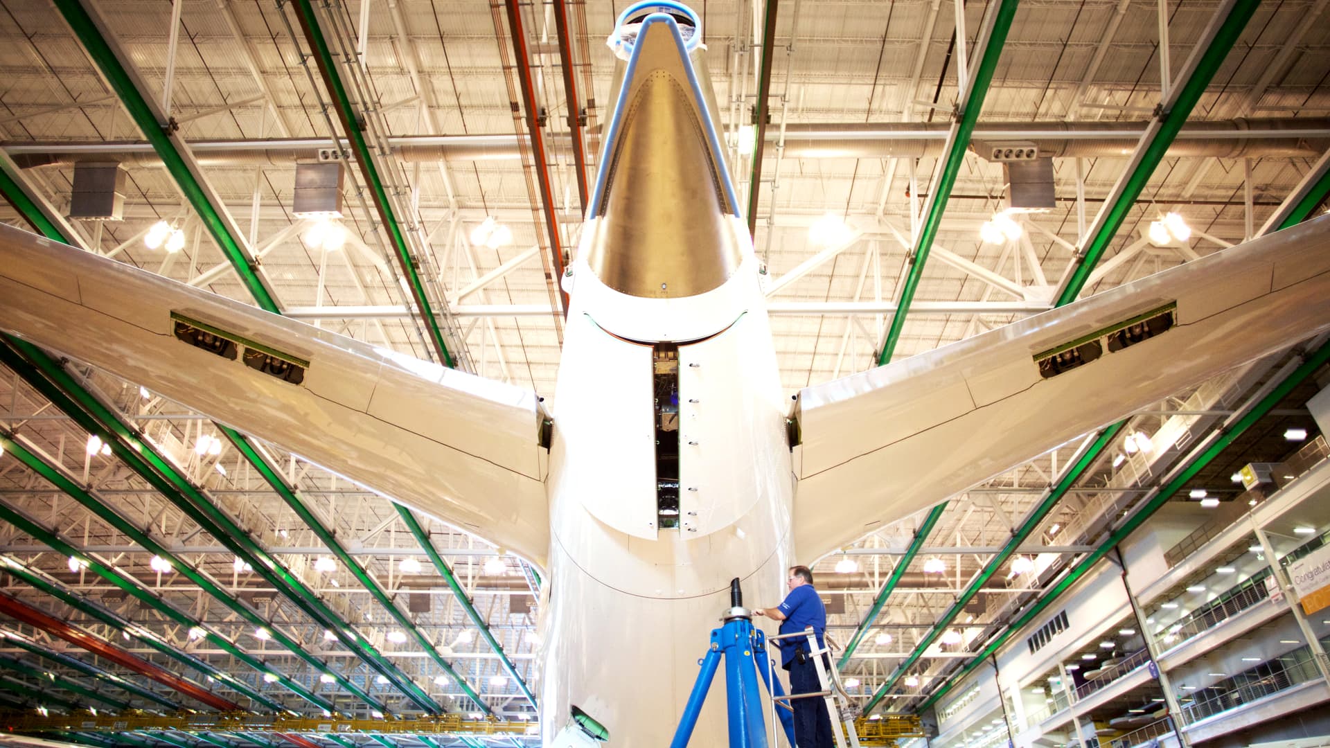 An employee works on the tail of a Boeing Co. Dreamliner 787 plane on the production line at the company's final assembly facility in North Charleston, South Carolina.