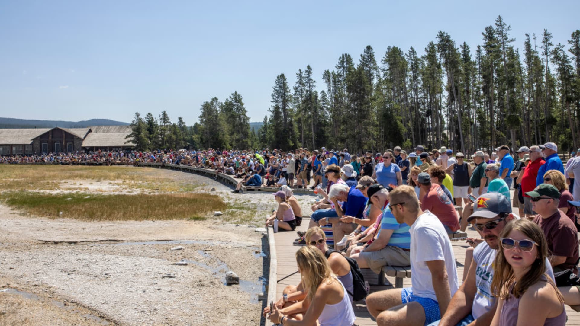 Crowds gather to watch the Old Faithful Geyser erupt at Yellowstone National Park on July 14, 2021.
