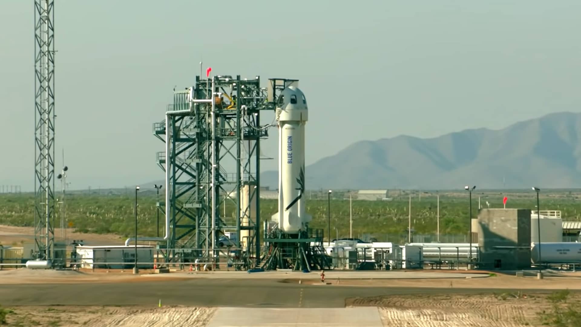 A New Shepard rocket stands ready to launch at the company's private facility before a previous uncrewed test flight.