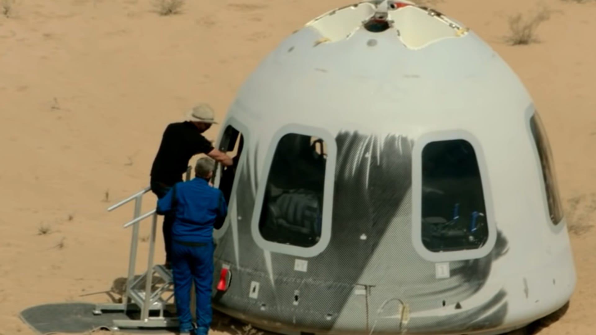 Jeff Bezos opens the hatch of a New Shepard capsule after an uncrewed test flight on April 14, 2021.