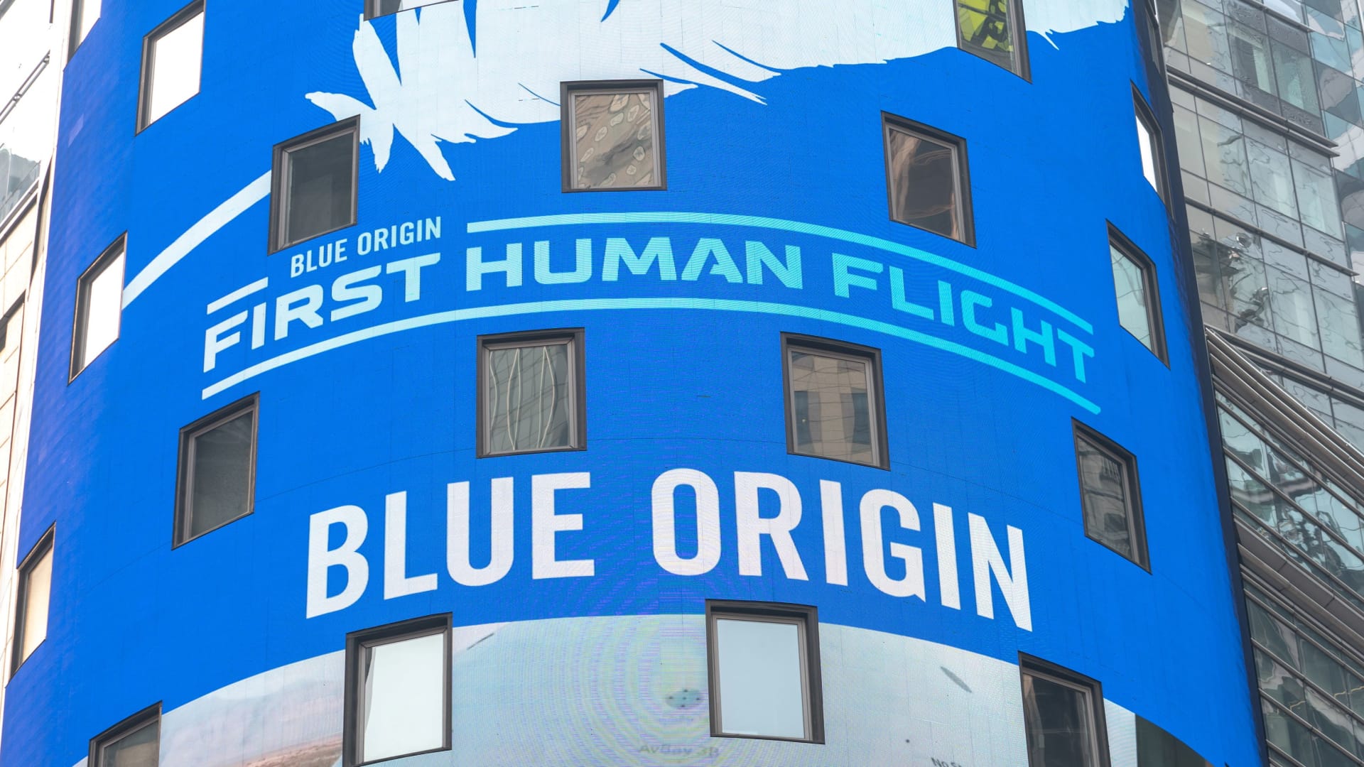 Blue Origin signage is displayed on a screen before the launch of billionaire American businessman Jeff Bezos and his three crewmates on Blue Origin's inaugural flight to the edge of space, in Times Square in New York City, U.S., July 20, 2021.