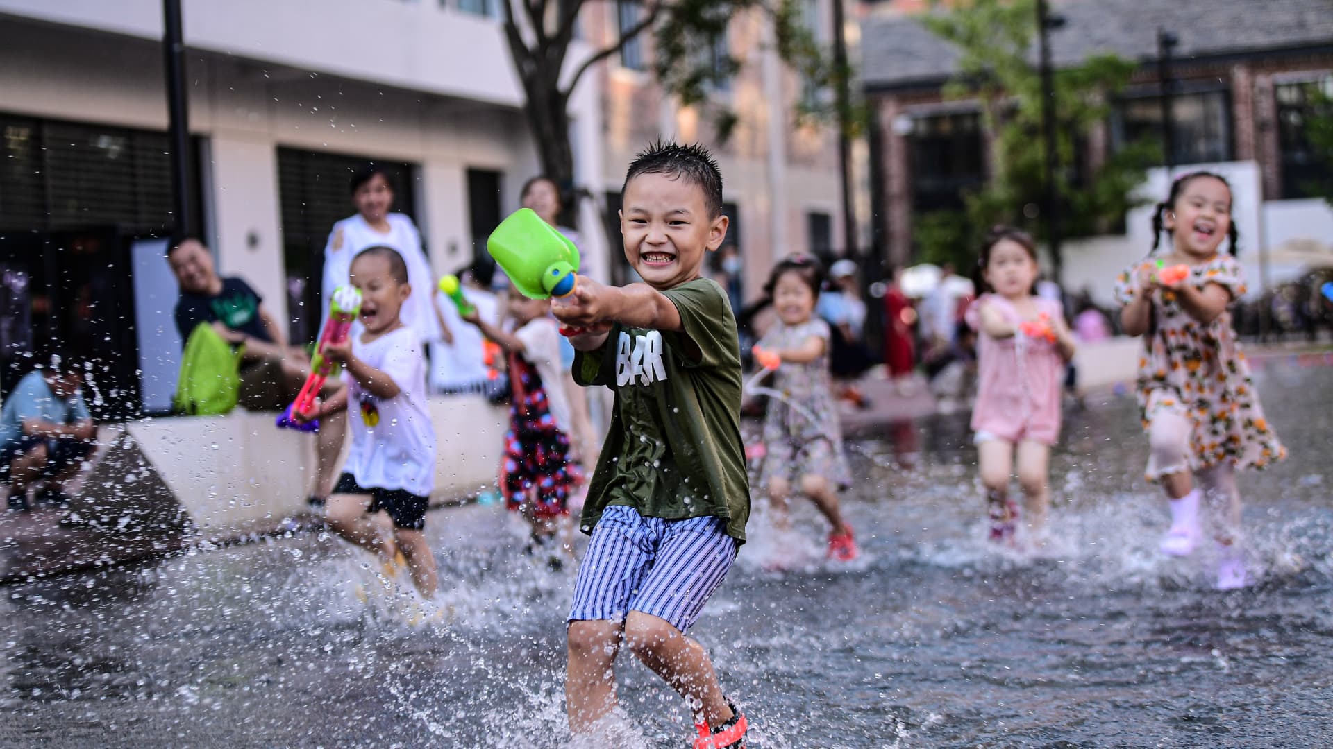 Children cool off in the water at a park as a heat wave hits the city on July 16, 2021 in Shenyang, Liaoning Province of China.