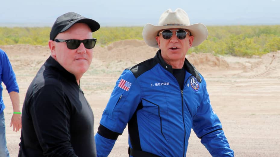 Billionaire American businessman Jeff Bezos walks with Blue Origin's President and CEO Bob Smith after Bezos flew on the company's inaugural flight to the edge of space, in the nearby town of Van Horn, Texas, U.S. July 20, 2021.