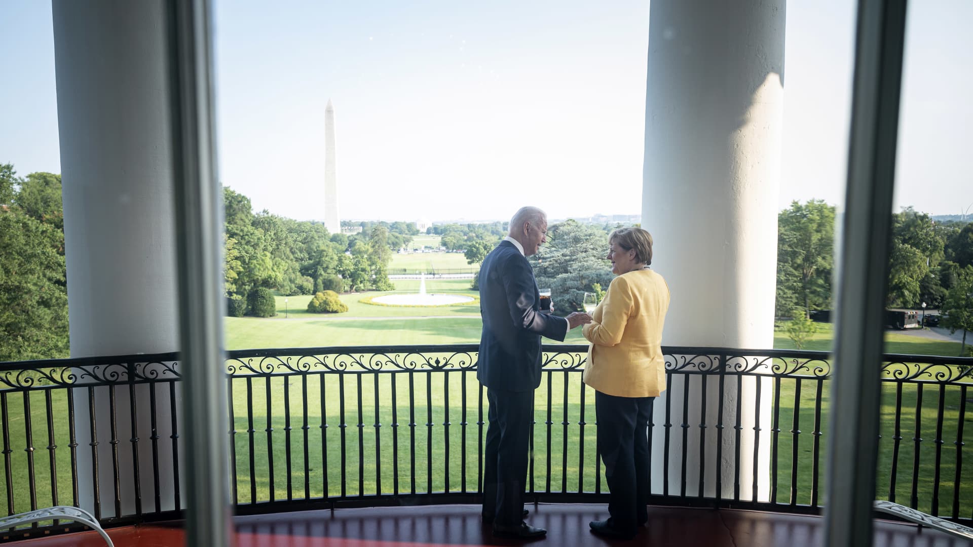 A handout photo provided by the German Government Press Office of German Chancellor Angela Merkel and U.S. President Joe Biden stand in the White House with a view of the Washington Monument on July 15, 2021 in Washington, DC.