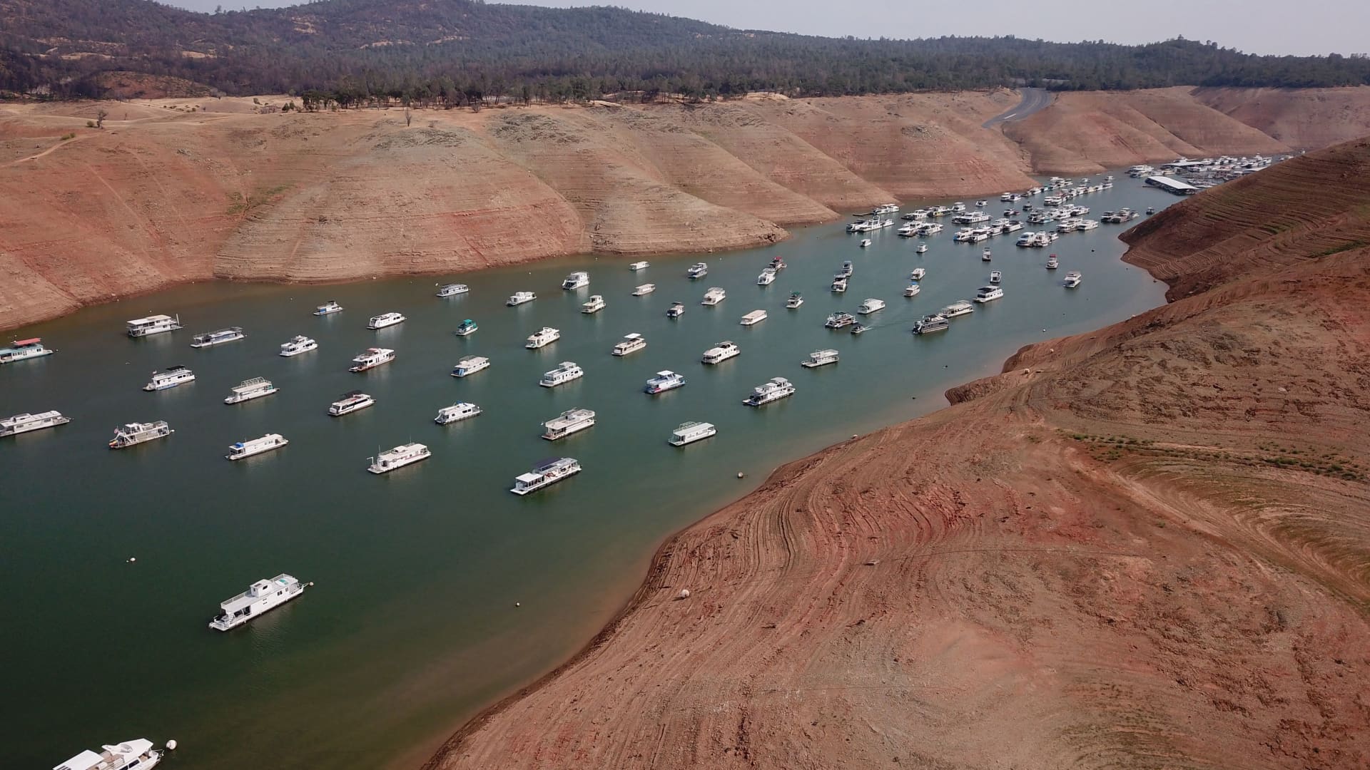 In this aerial photo houseboats sit in low water on Lake Oroville as California's drought emergency worsens, July 25, 2021 in Oroville, California.