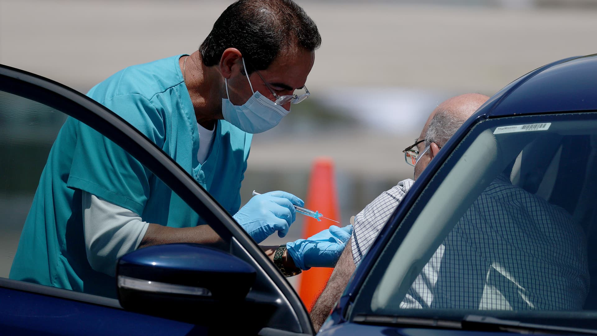 A healthcare worker at a drive-thru site setup by Miami-Dade and Nomi Health in Tropical Park prepares to administer a COVID-19 vaccine on July 26, 2021 in Miami, Florida.