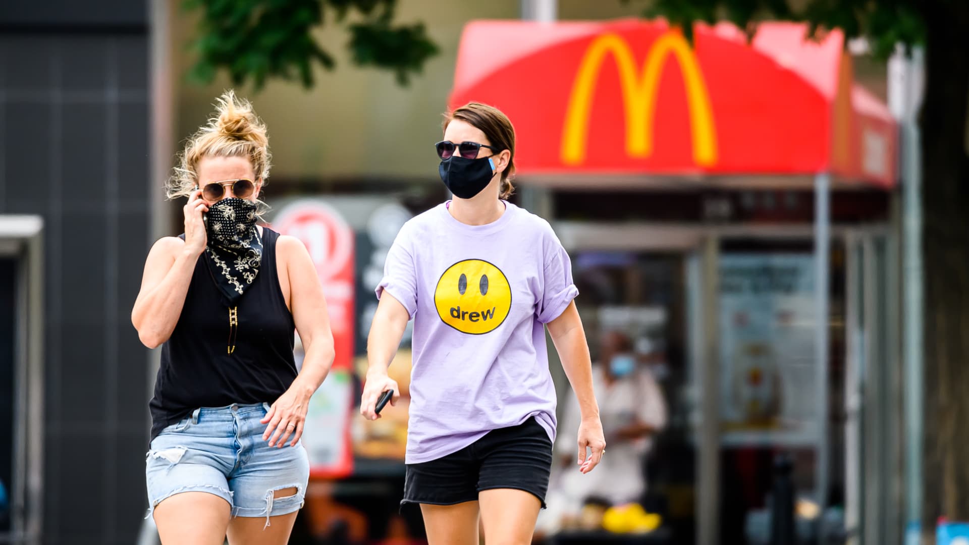 People wear protective face masks outside McDonald's in Union Square as the city continues Phase 4 of re-opening following restrictions imposed to slow the spread of coronavirus on July 30, 2020 in New York City.