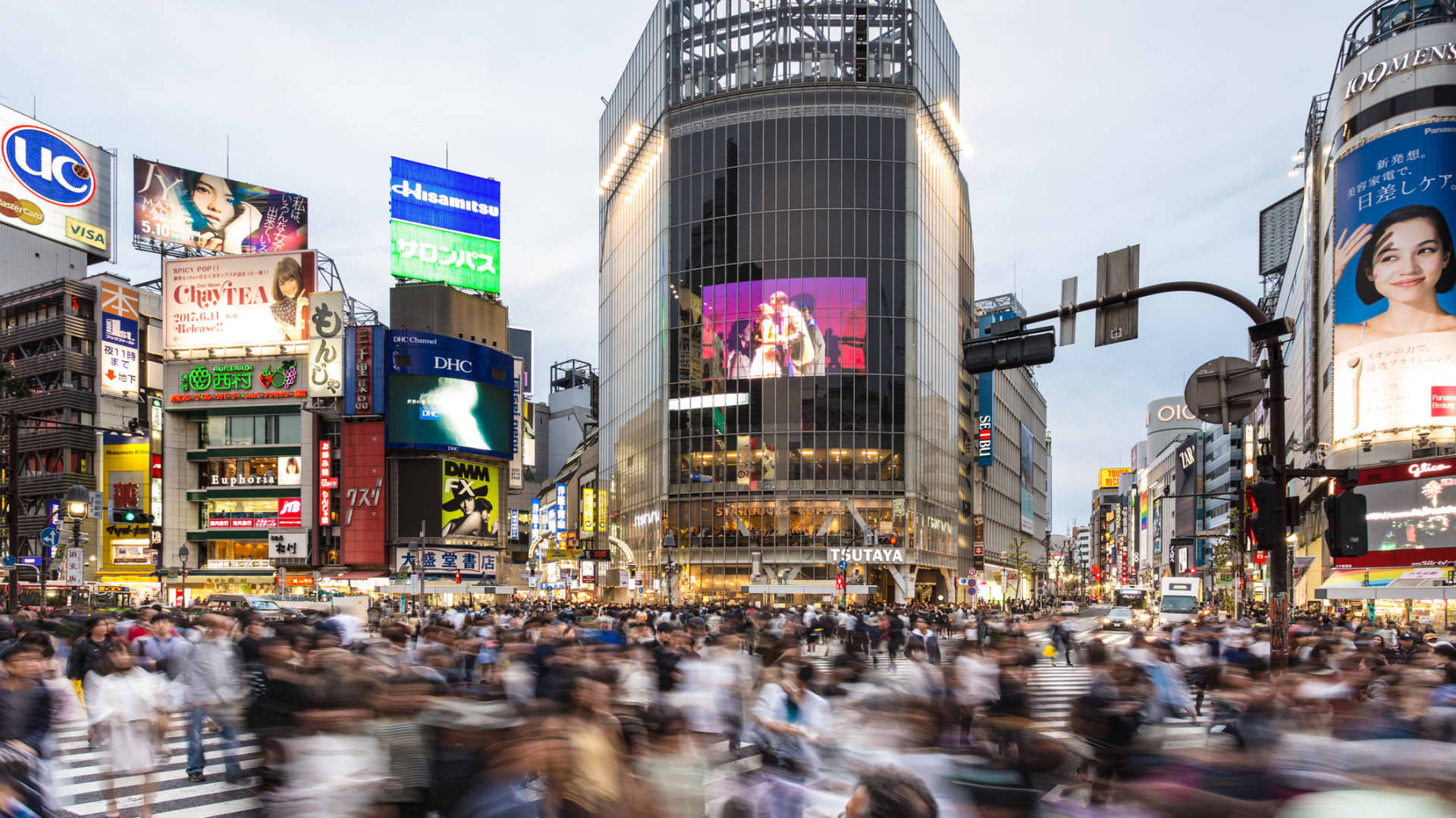 Crowds walk through Shibuya Crossing in Tokyo, Japan.