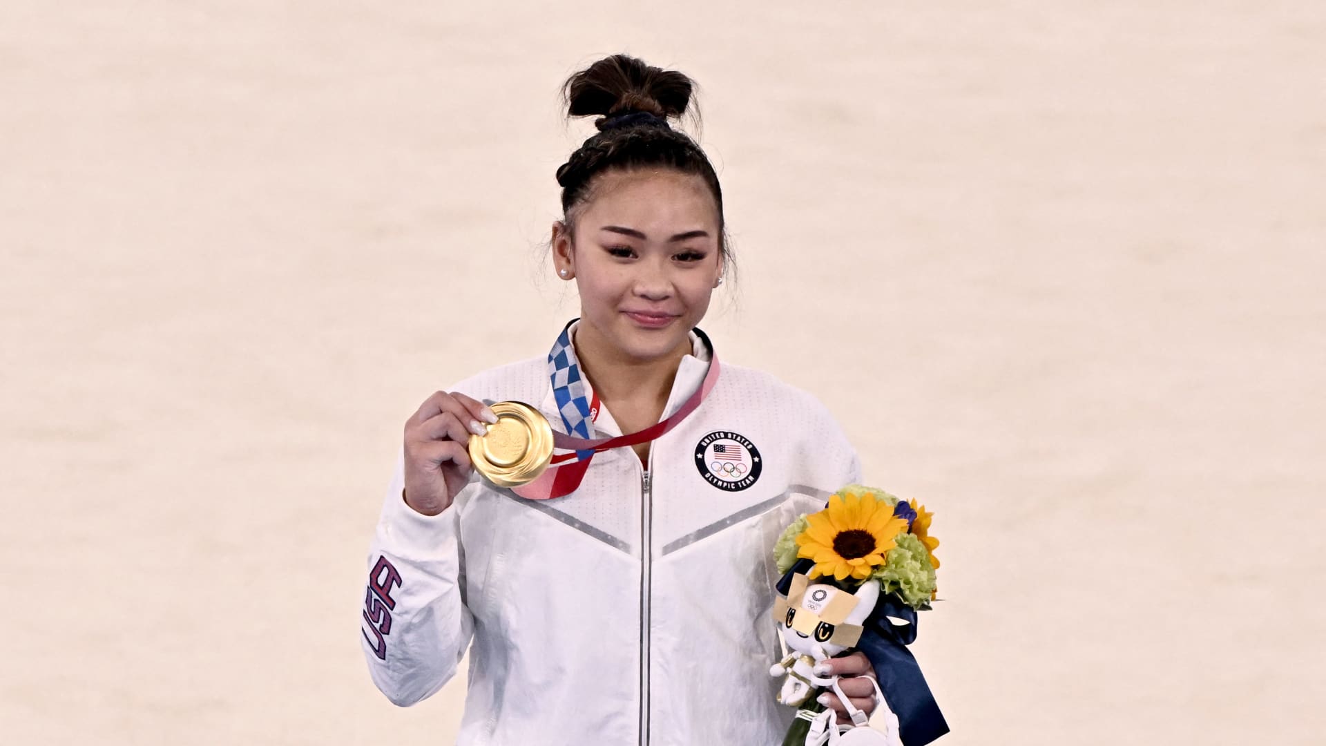 USA's Sunisa Lee (gold) celebrate son the podium during the medal ceremony of the artistic gymnastics women's all-around final during the Tokyo 2020 Olympic Games at the Ariake Gymnastics Centre in Tokyo on July 29, 2021.