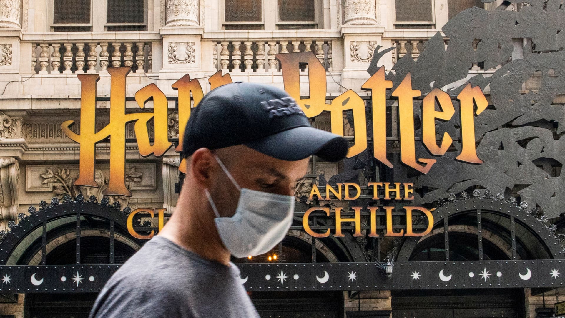 A man wears a mask to prevent against the spread of coronavirus disease (COVID-19) while he walks around Theater District in Times Square, as the highly transmissible Delta variant has led to a surge in infections, in New York City, U.S., July 30, 2021.