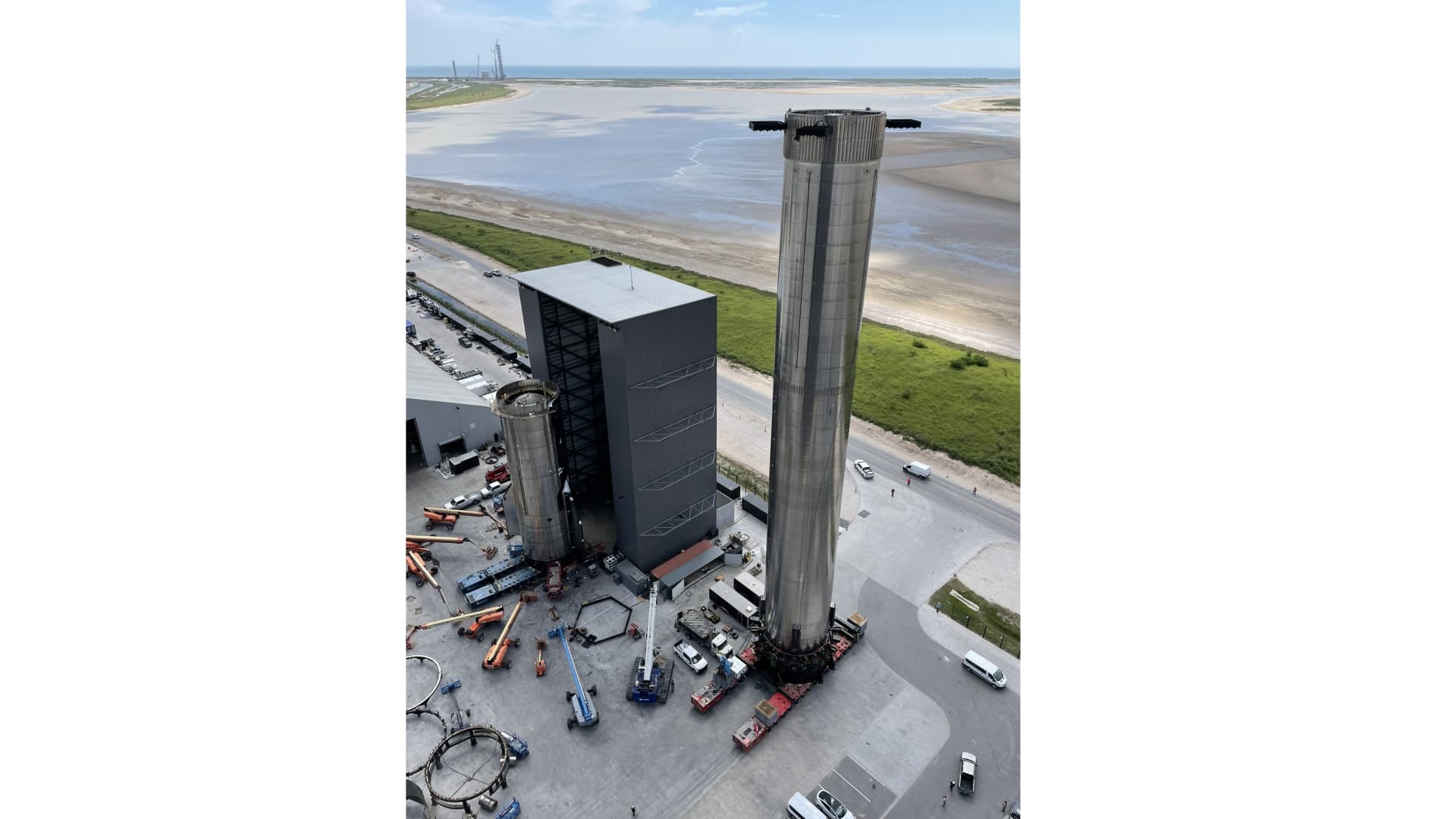 SpaceX rolls out Super Heavy Booster 4 in preparation for the company's first orbital Starship launch.