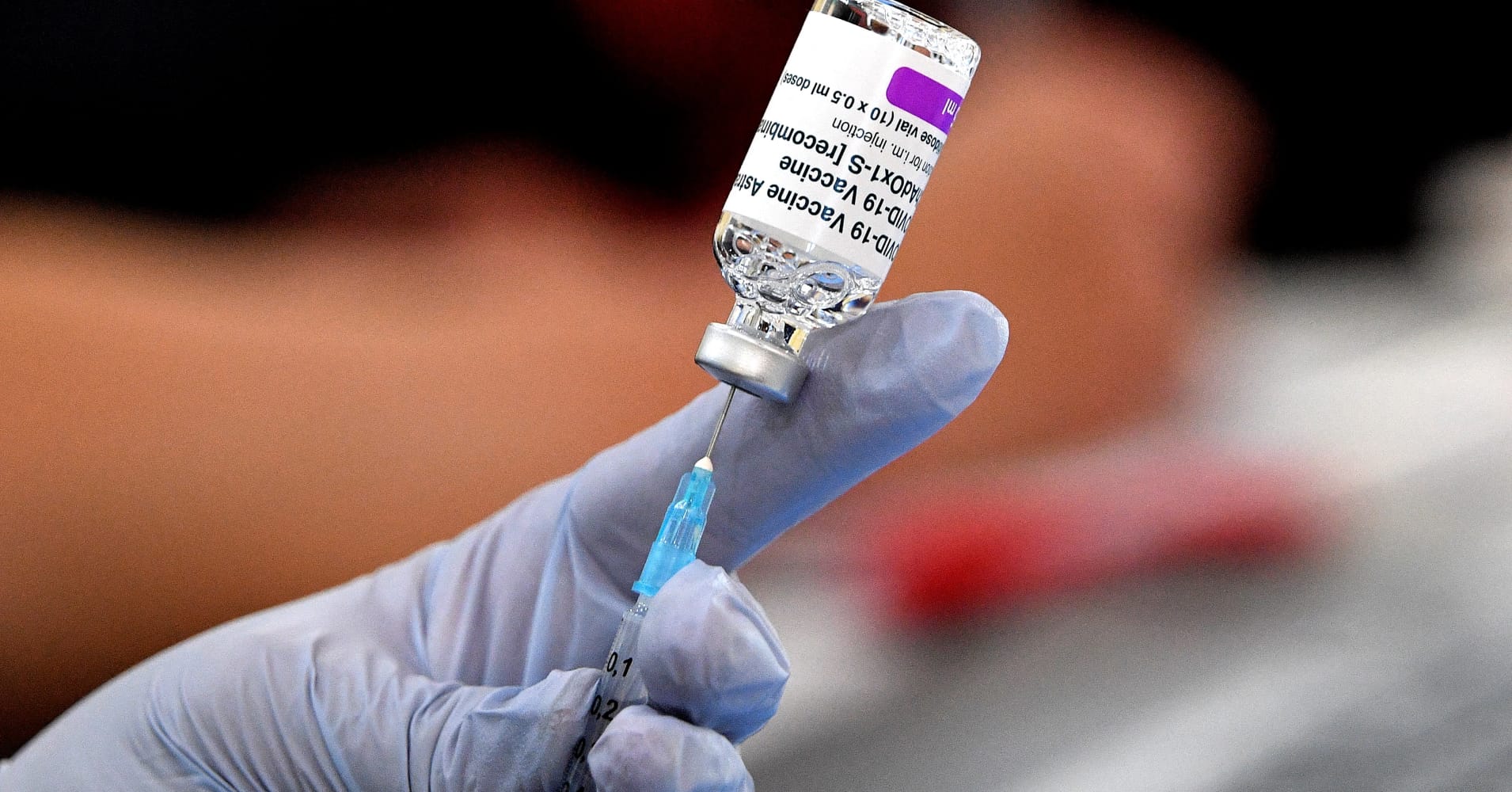 A paramedic prepares doses of AstraZeneca vaccine for patients at a walk-in COVID-19 clinic inside a Buddhist temple in the Smithfield suburb of Sydney on August 4, 2021.