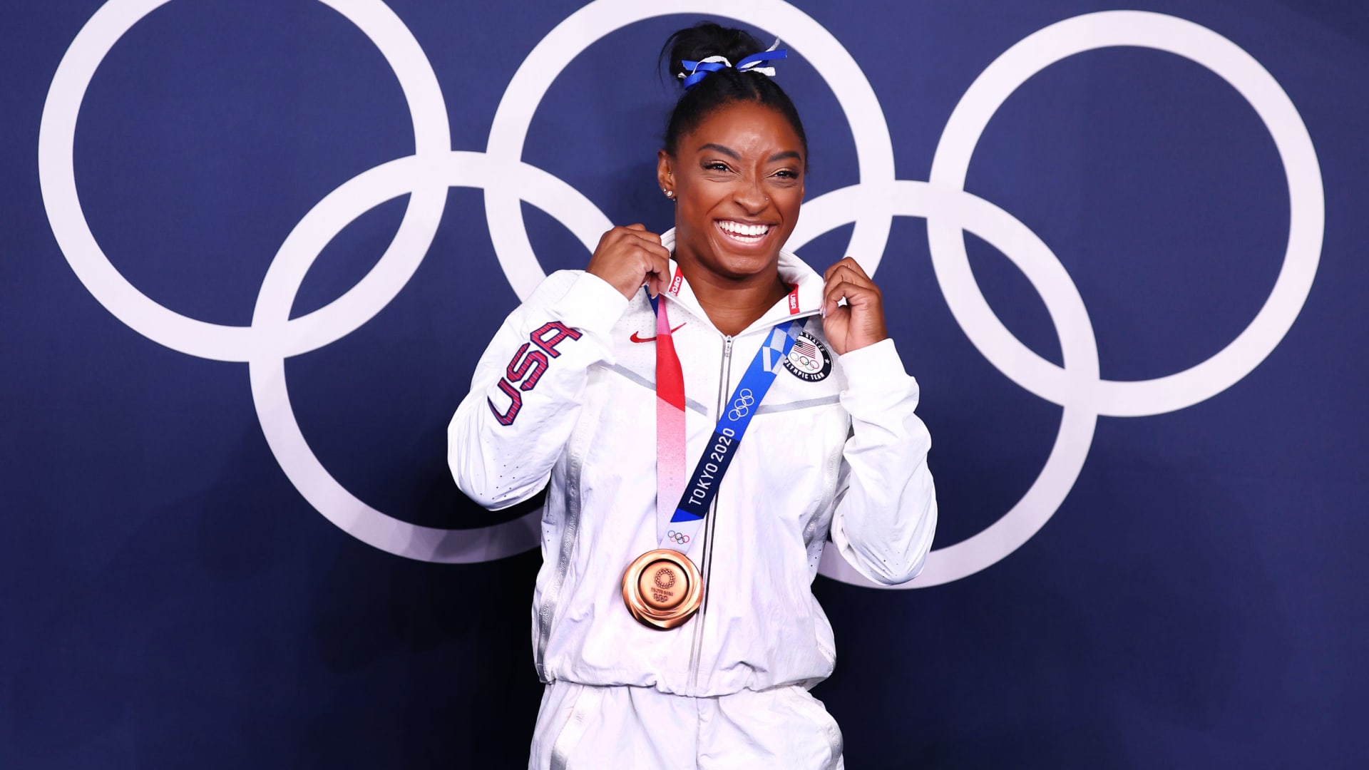 Bronze medallist Simone Biles of the United States poses in front of the Olympic rings at the Tokyo 2020 Olympics, Women's Beam Medal Ceremony, Ariake Gymnastics Centre, Tokyo, Japan, August 3, 2021.