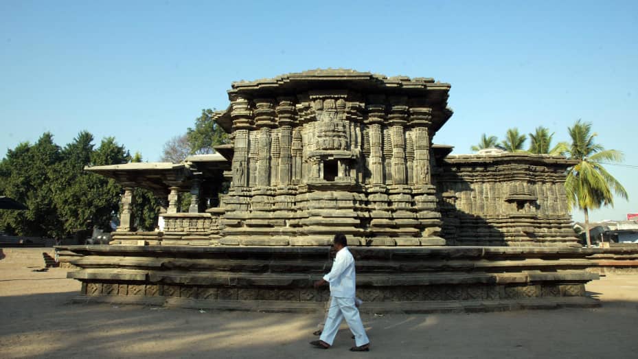 Indian tourists walk beside the historic thousand pillar temple in Warangal District. The temple was built during the Kakatiya dynasty that ruled the Andhra Pradesh region.