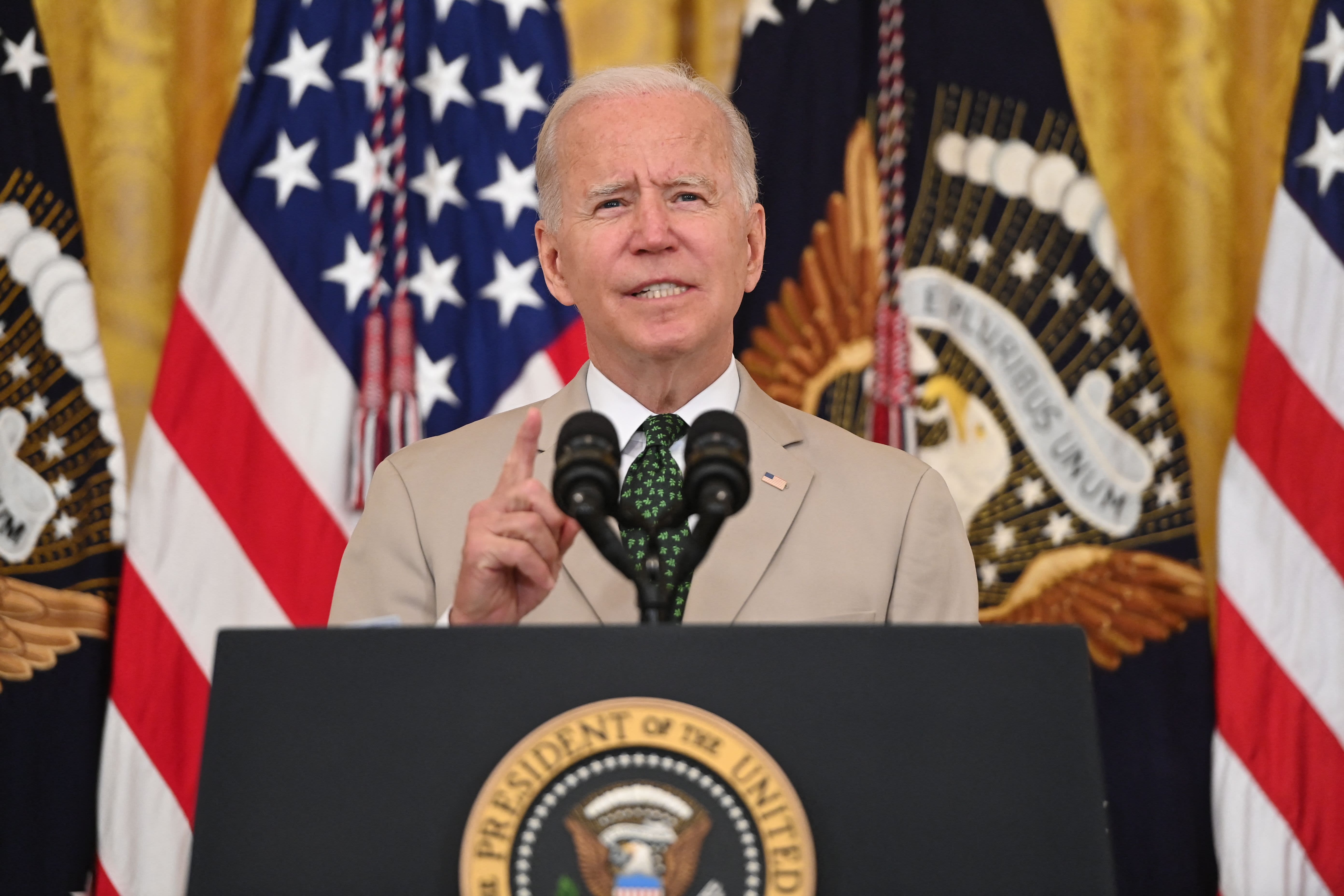 Biden skips victory lap after strong July jobs report, warns of economic peril from rising Covid cases