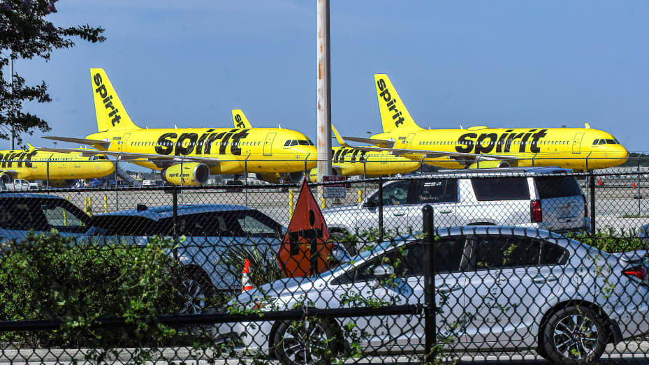 Spirit Airlines aircraft are seen parked at the end of a runway at Orlando International Airport on the sixth day the airline has cancelled hundreds of flights.