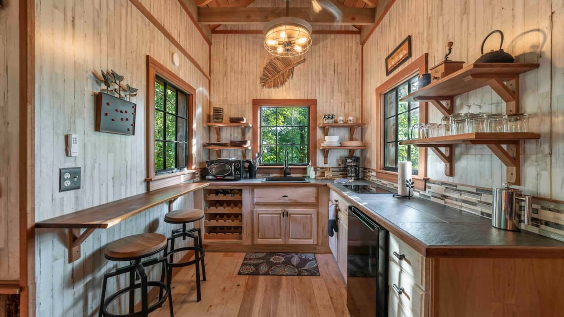 The contemporary kitchen in Trinity Treehouse, outside of Atlanta, has a wine rack and bar area.
