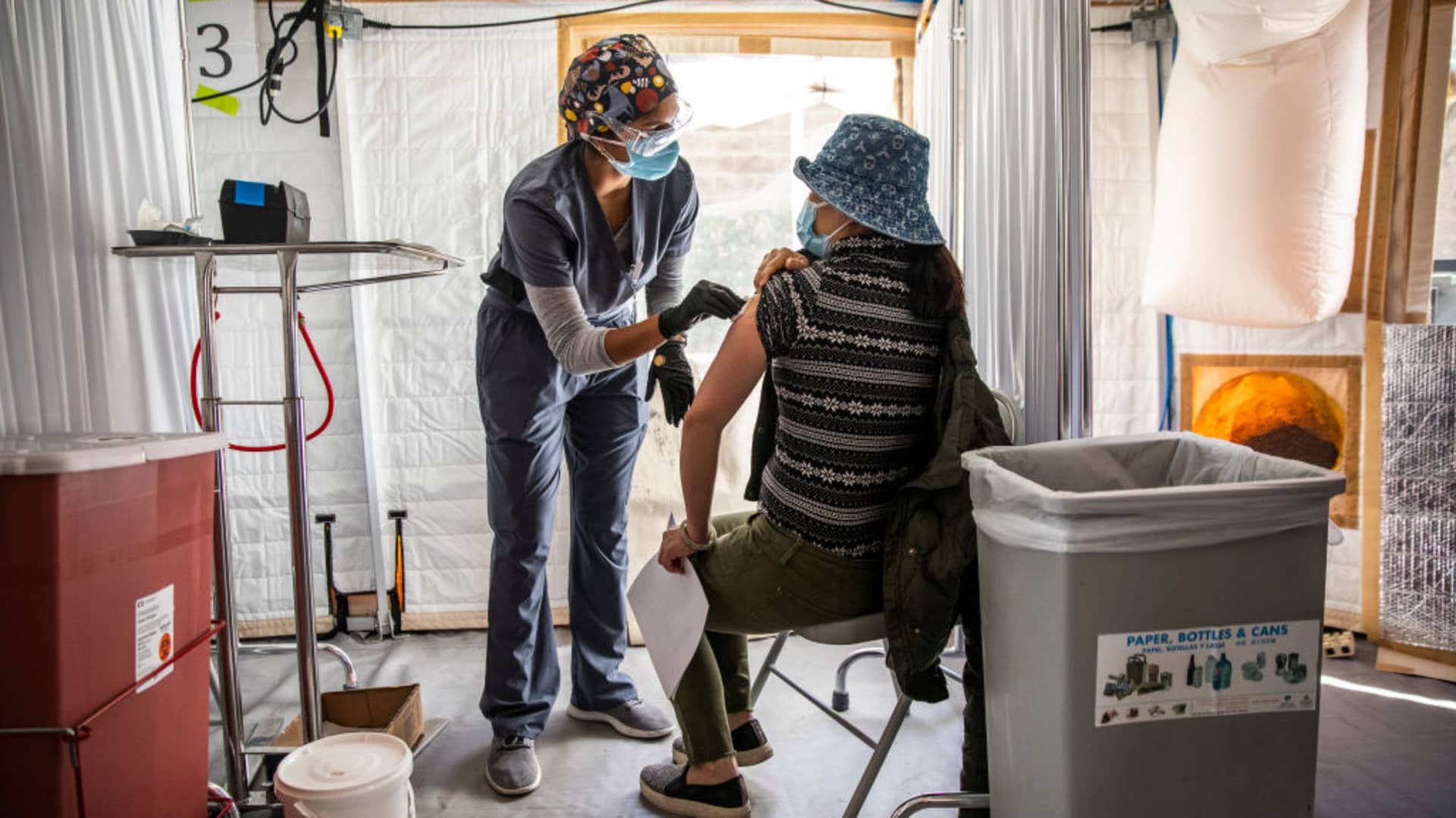 Anjali Sundararaman, a student nurse at San Francisco State University, administers a dose of Moderna COVID-19 vaccine to Cuixia Xu during a vaccination clinic at the Southeast Health Center in the Bayview-Hunters Point neighborhood in San Francisco, California on Monday, Feb. 8, 2021.