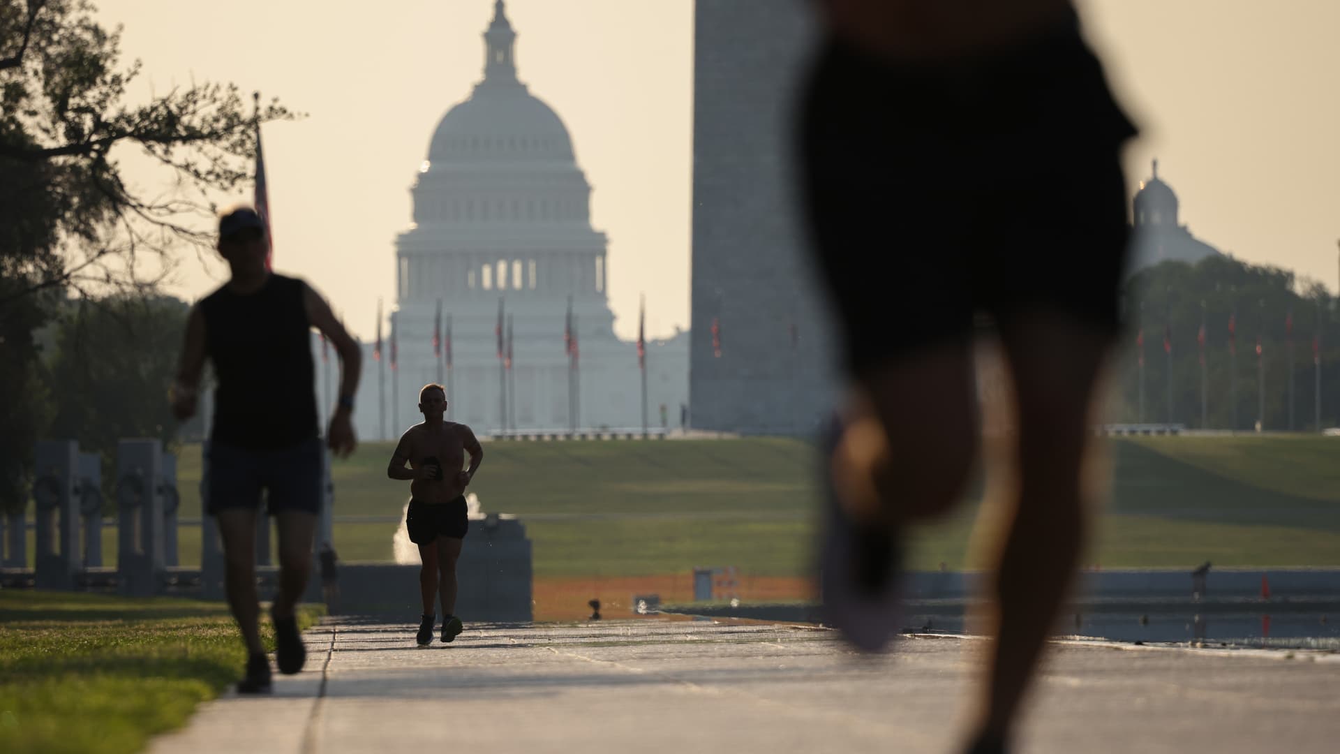 People exercise on the National Mall as temperatures are expected to reach near 100 degrees Fahrenheit on August 13, 2021 in Washington, DC.