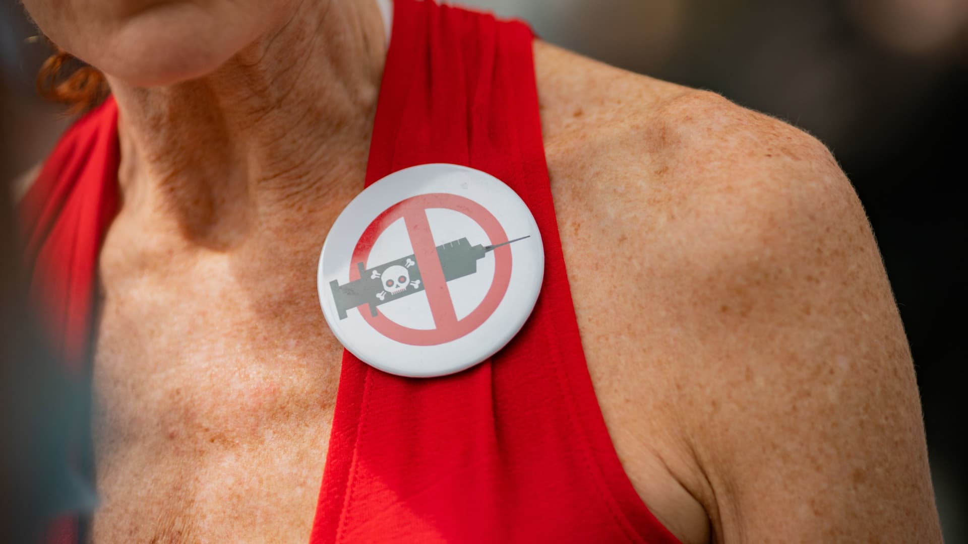 A woman wearing a pin during an anti-mandatory coronavirus disease (COVID-19) vaccine protest held outside New York City Hall in New York, August 16, 2021.