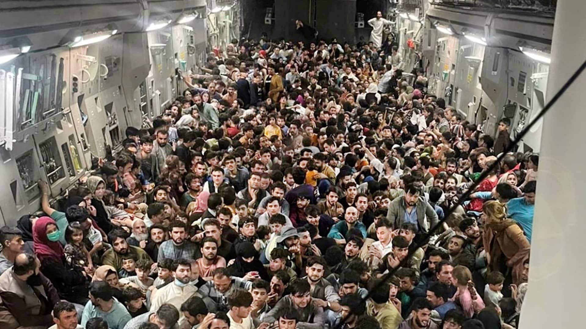 Evacuees crowd the interior of a U.S. Air Force C-17 Globemaster III transport aircraft, carrying some 640 Afghans to Qatar from Kabul, Afghanistan August 15, 2021.