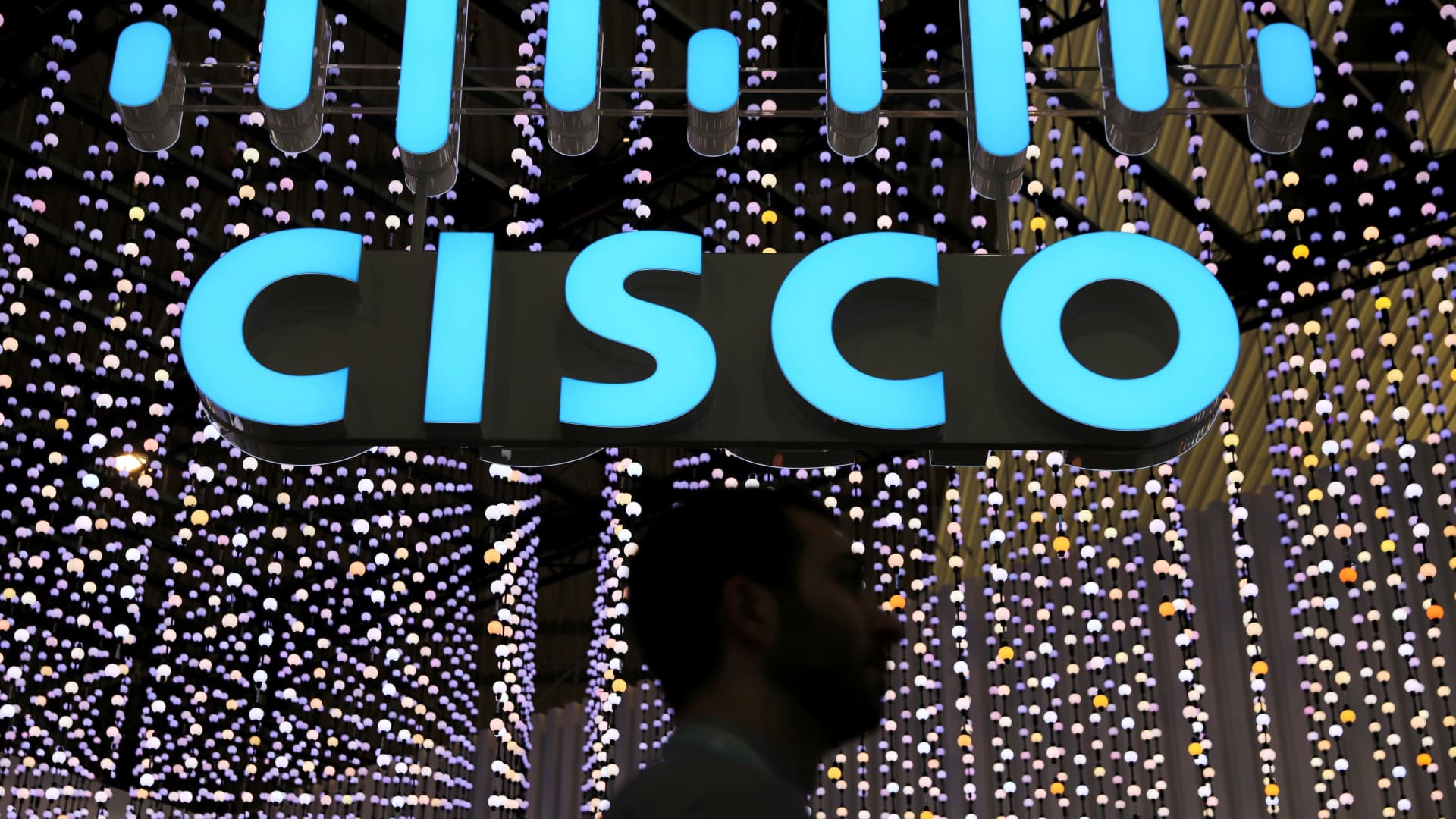 A man passes under a Cisco logo at the Mobile World Congress in Barcelona, Spain February 25, 2019.