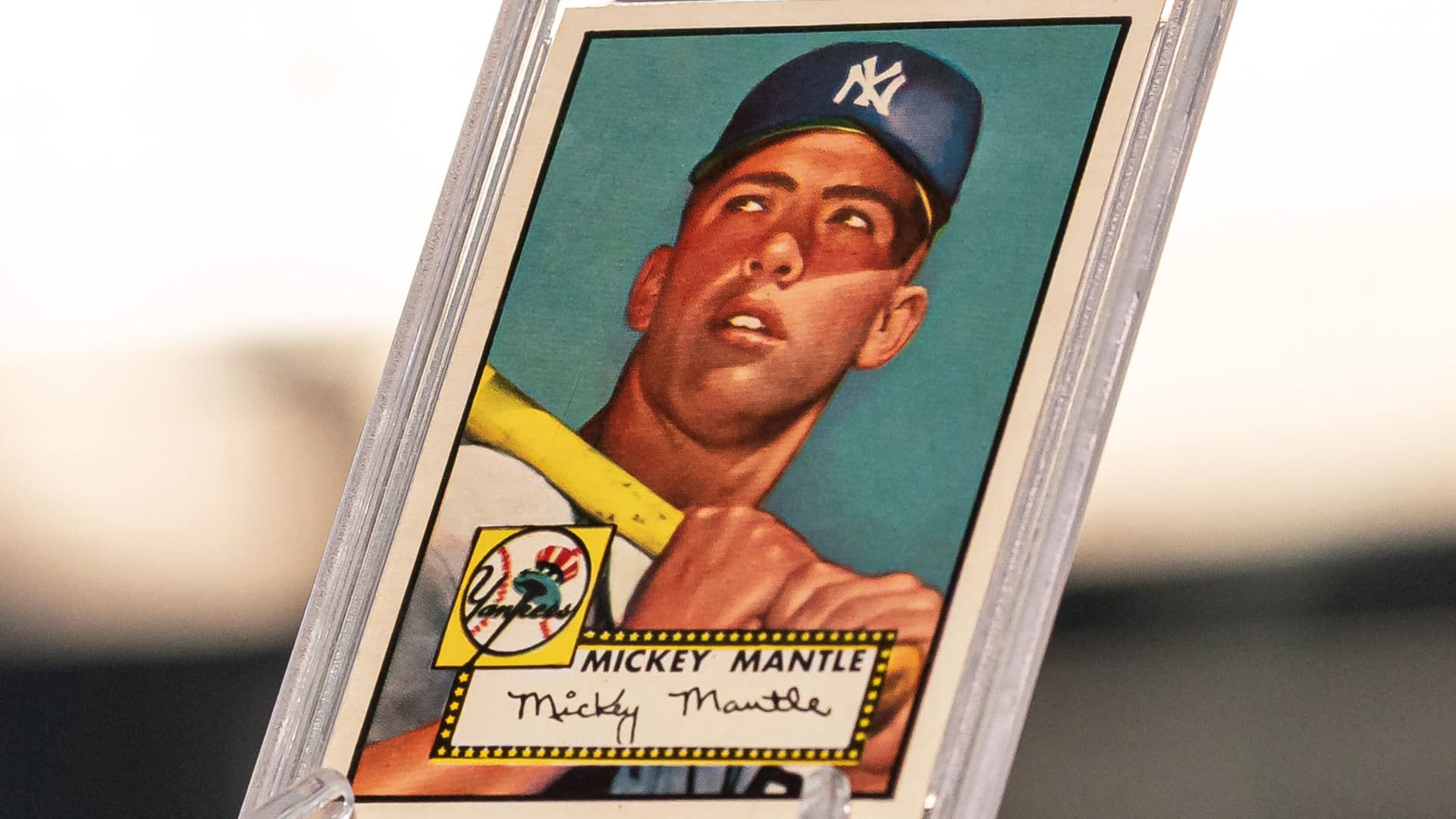 The 1952 Topps Mickey Mantle rookie card from the collection of Marshall Fogel arrives at McGregor Square's Rally Hotel.