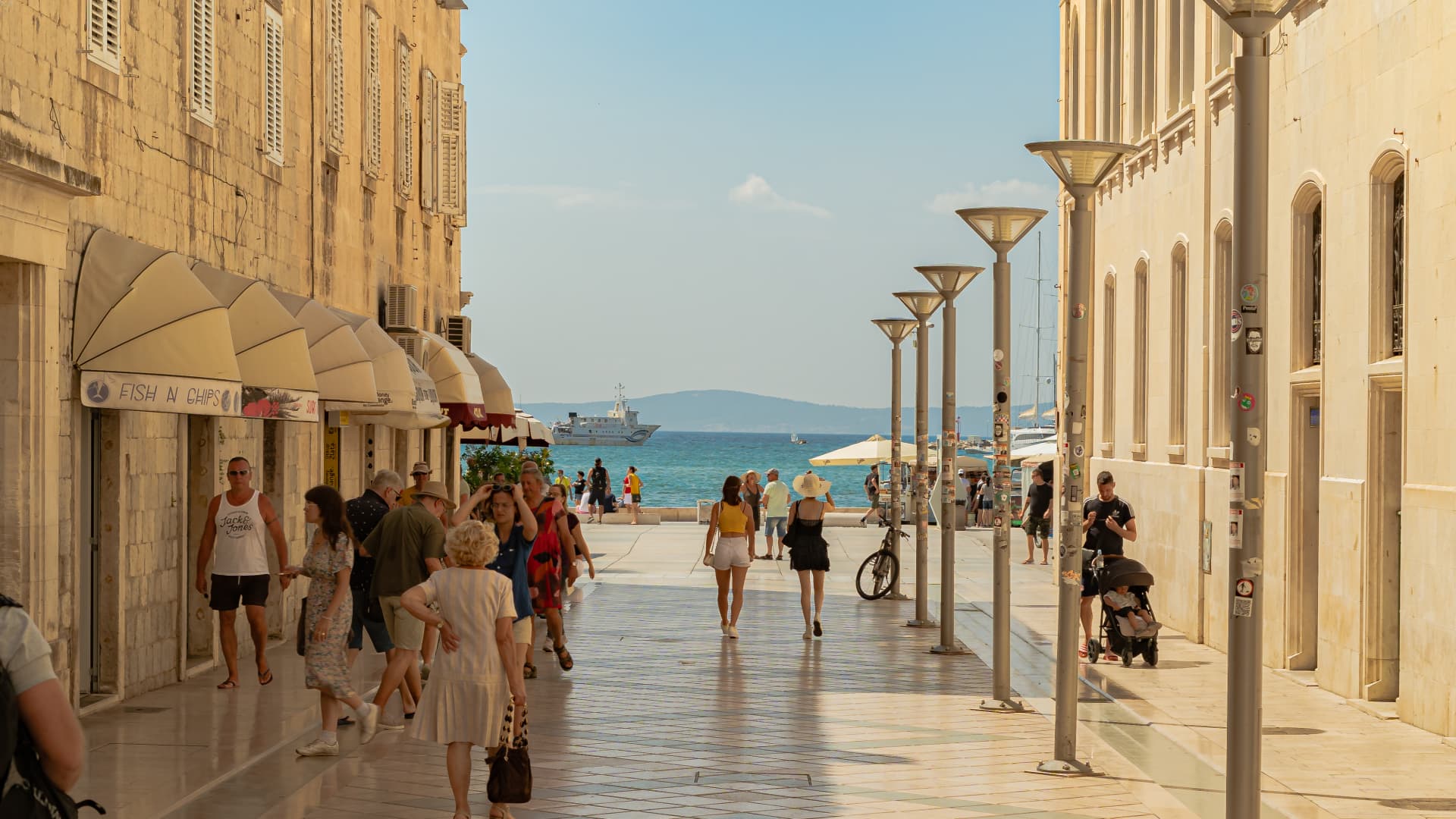 Marmontova Ulica, a busy street in Split filled with several shops and restaurants. Pictured in the distance is the island of Brač.