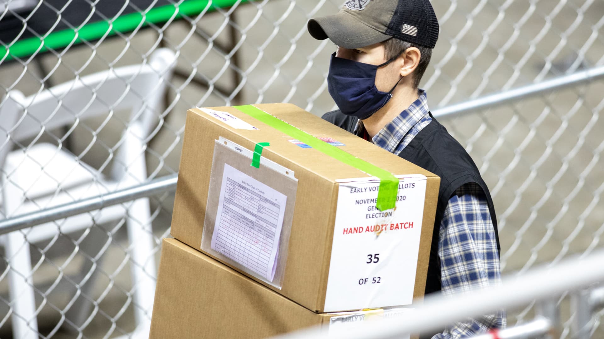 A contractor working for Cyber Ninjas, who was hired by the Arizona State Senate transports ballots from the 2020 general election at Veterans Memorial Coliseum on May 1, 2021 in Phoenix, Arizona.