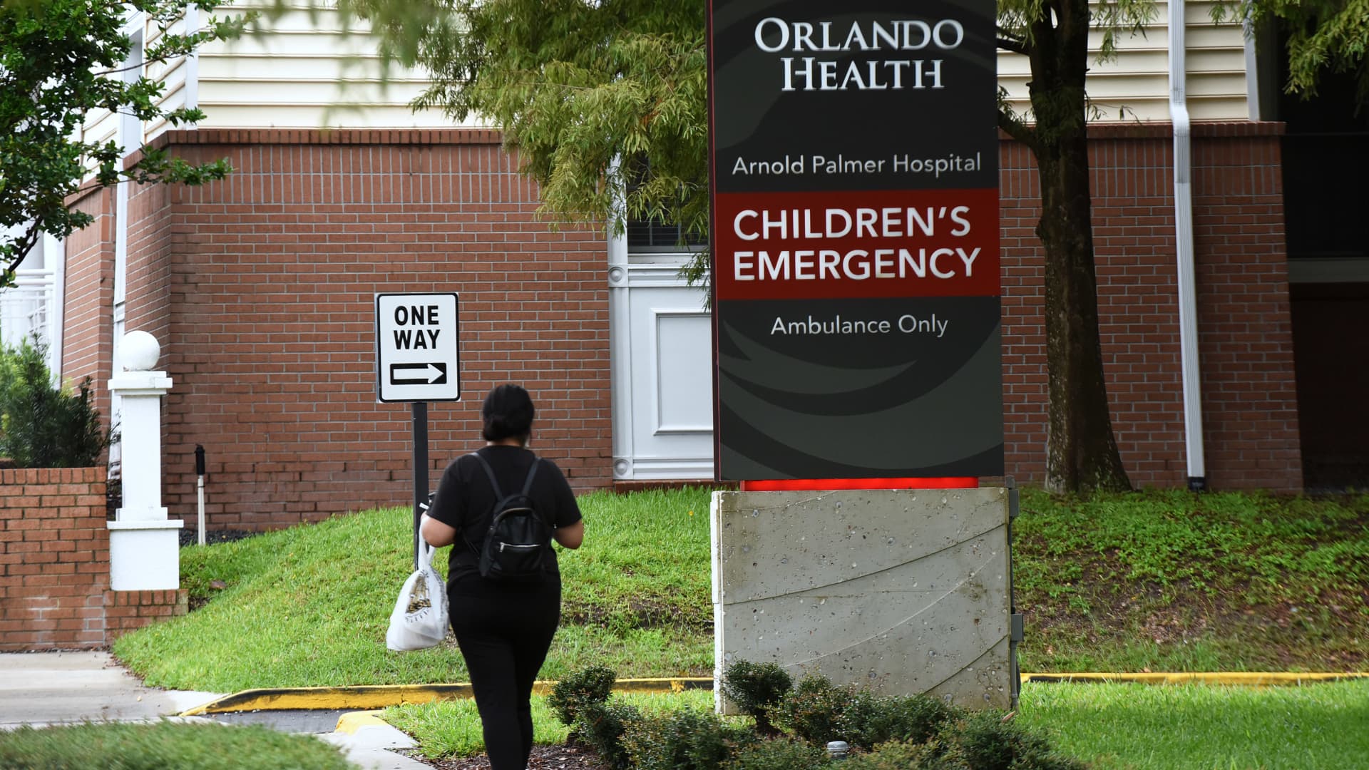 A woman walks near the emergency entrance at Arnold Palmer Hospital for Children.