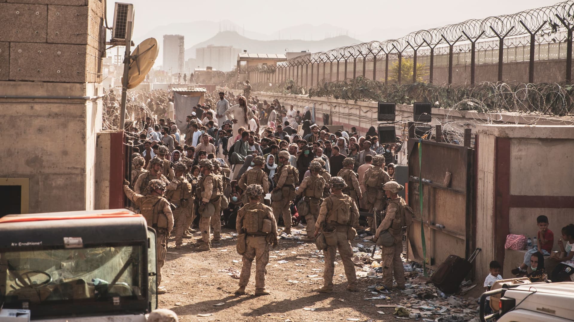 U.S. Marines provide assistance at an Evacuation Control Checkpoint (ECC) during an evacuation at Hamid Karzai International Airport, Afghanistan, August 22, 2021.