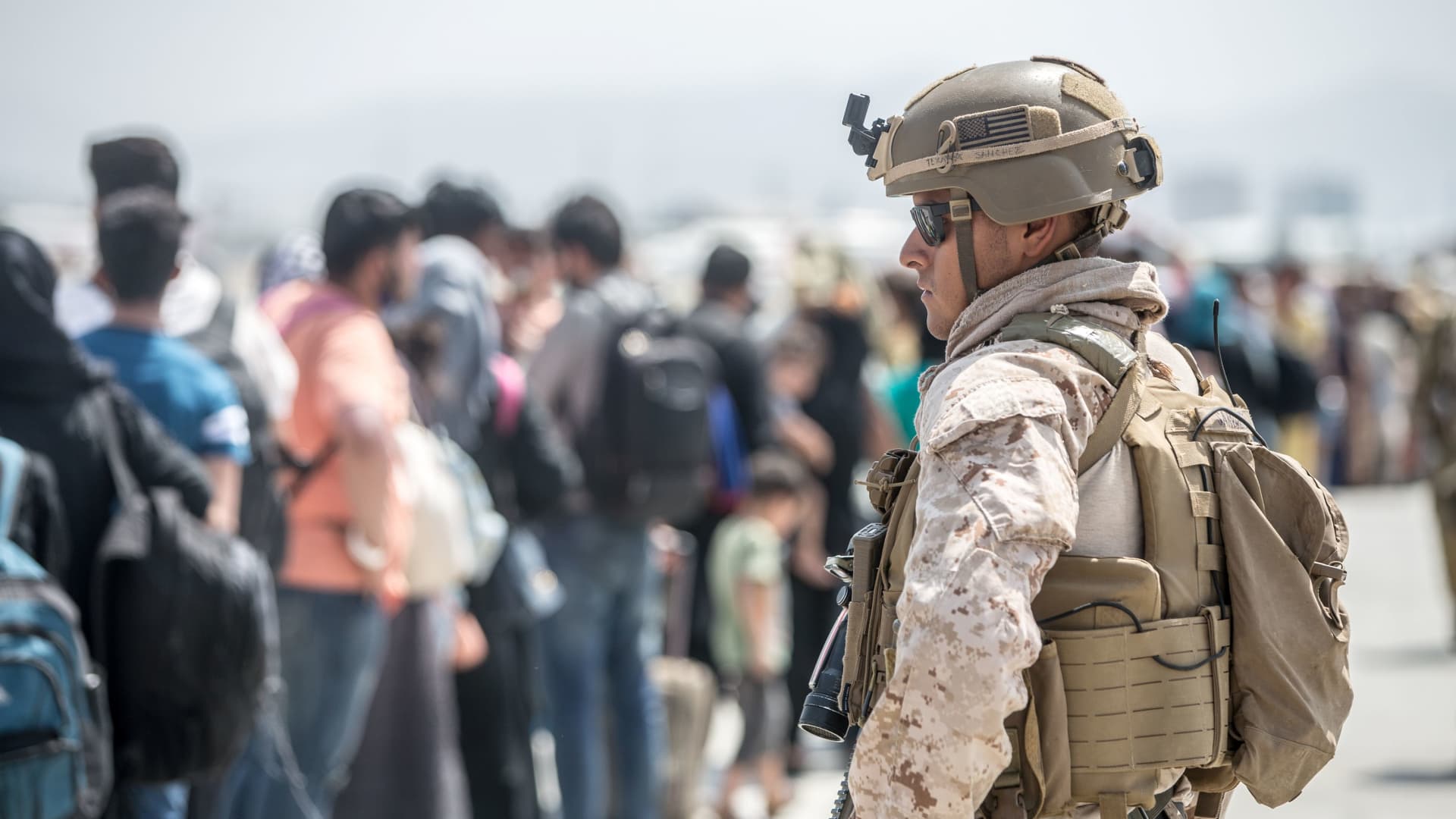 A U.S. Marine provides assistance during an evacuation at Hamid Karzai International Airport, Afghanistan, August 22, 2021.